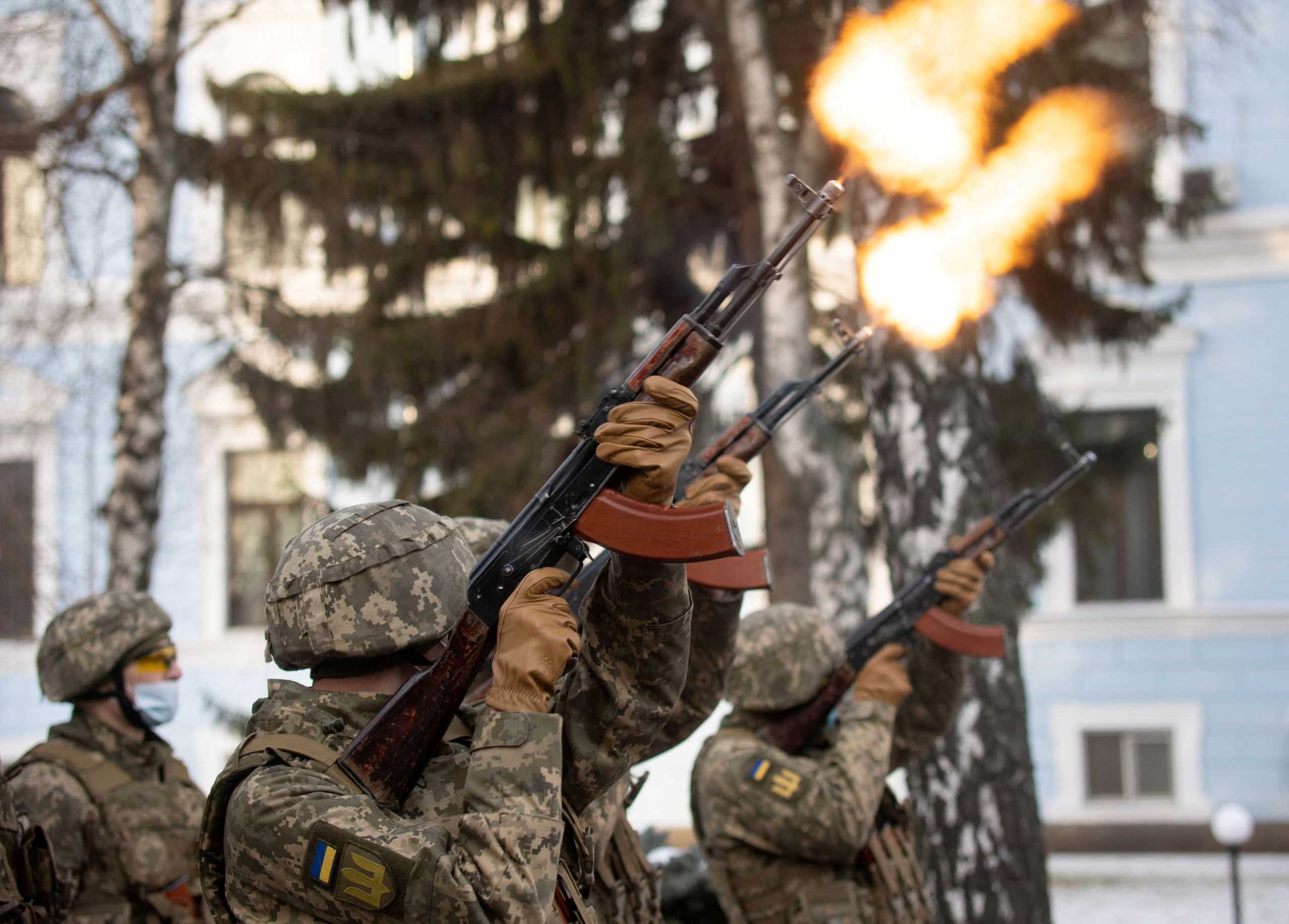 Service members fire a salute during a ceremony in tribute to fallen defenders of Ukraine, including the soldiers killed during a battle with pro-Russian rebels for the Donetsk airport this day in 2015, at a memorial near the headquarters of the Defence Ministry in Kyiv, Ukraine January 20, 2022. Ukrainian Presidential Press Service