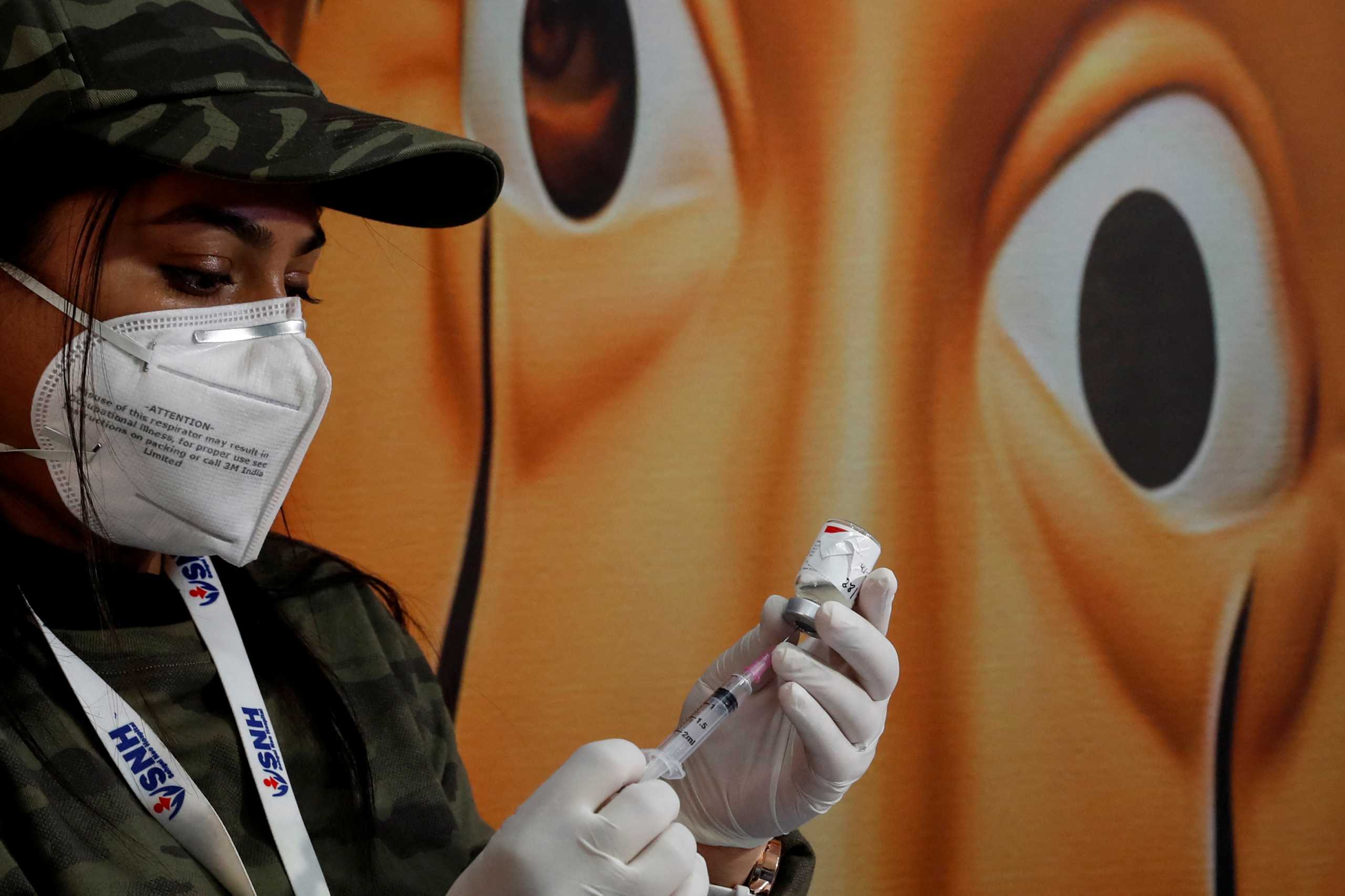 A healthcare worker fills a syringe with a dose of the COVAXIN coronavirus disease (COVID-19) vaccine manufactured by Bharat Biotech, during a vaccination drive for children aged 15-18 in New Delhi, India, January 3, 2022. REUTERS