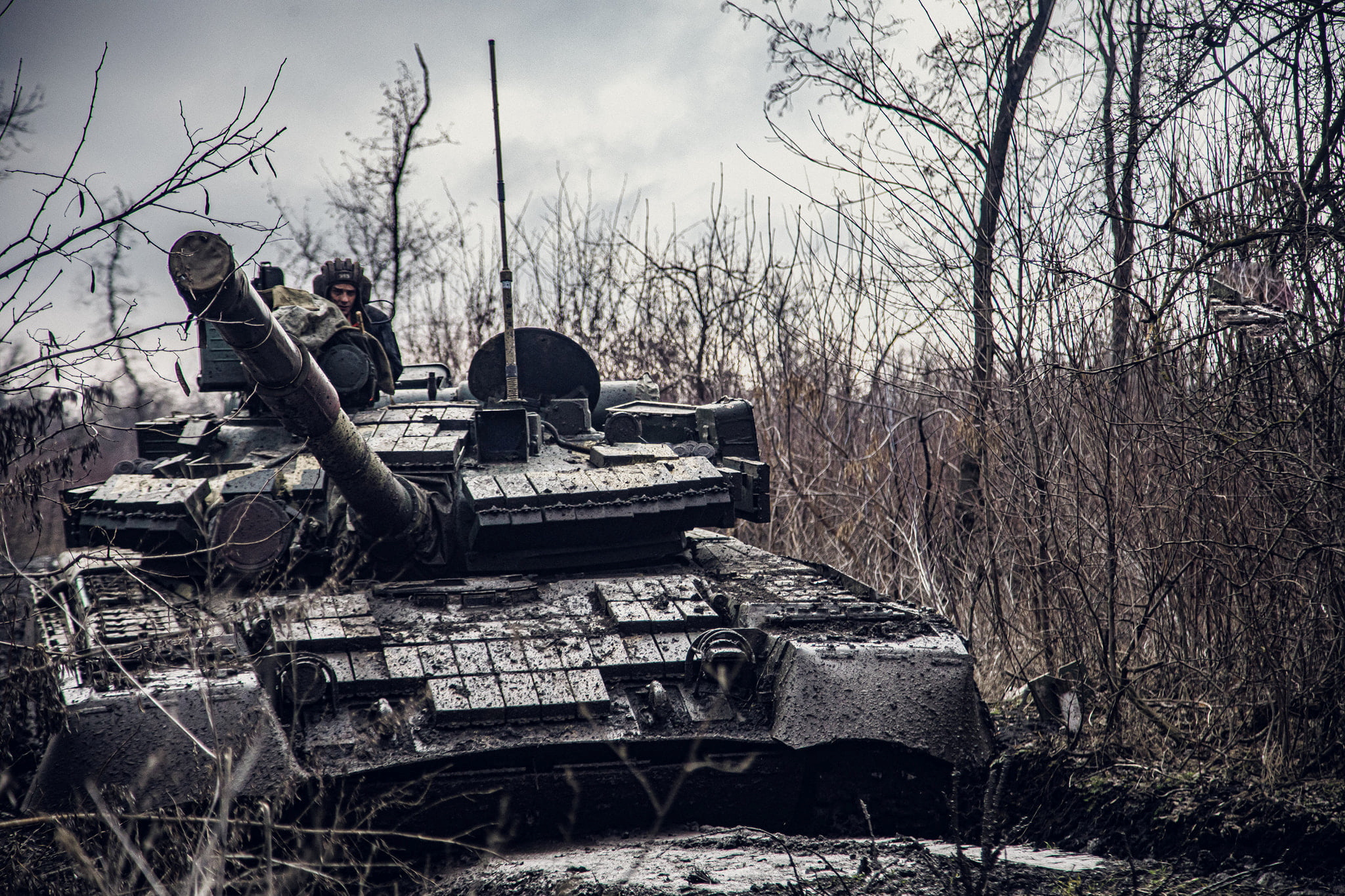 A service member of the Ukrainian Naval Infantry Corps (Marine Corps) rides a tank during drills at a training ground in an unknown location in Ukraine, in this handout picture released February 18, 2022. Press Service of the Ukrainian Naval Forces