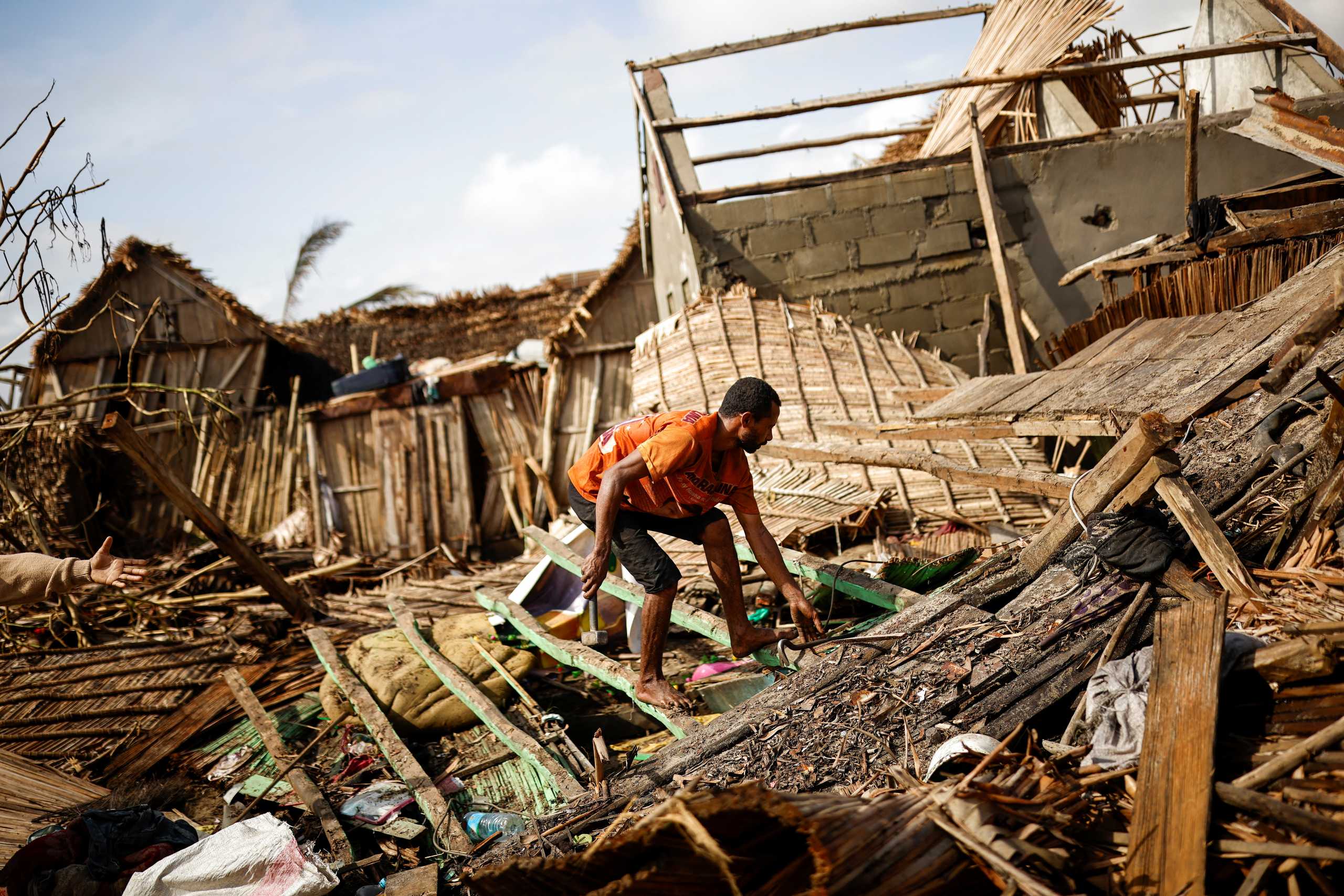 A man works on the destroyed house of Philibert Jean Claude Razananoro, in the aftermath of Cyclone Batsirai, in the town of Mananjary, Madagascar, February 8, 2022. REUTERS