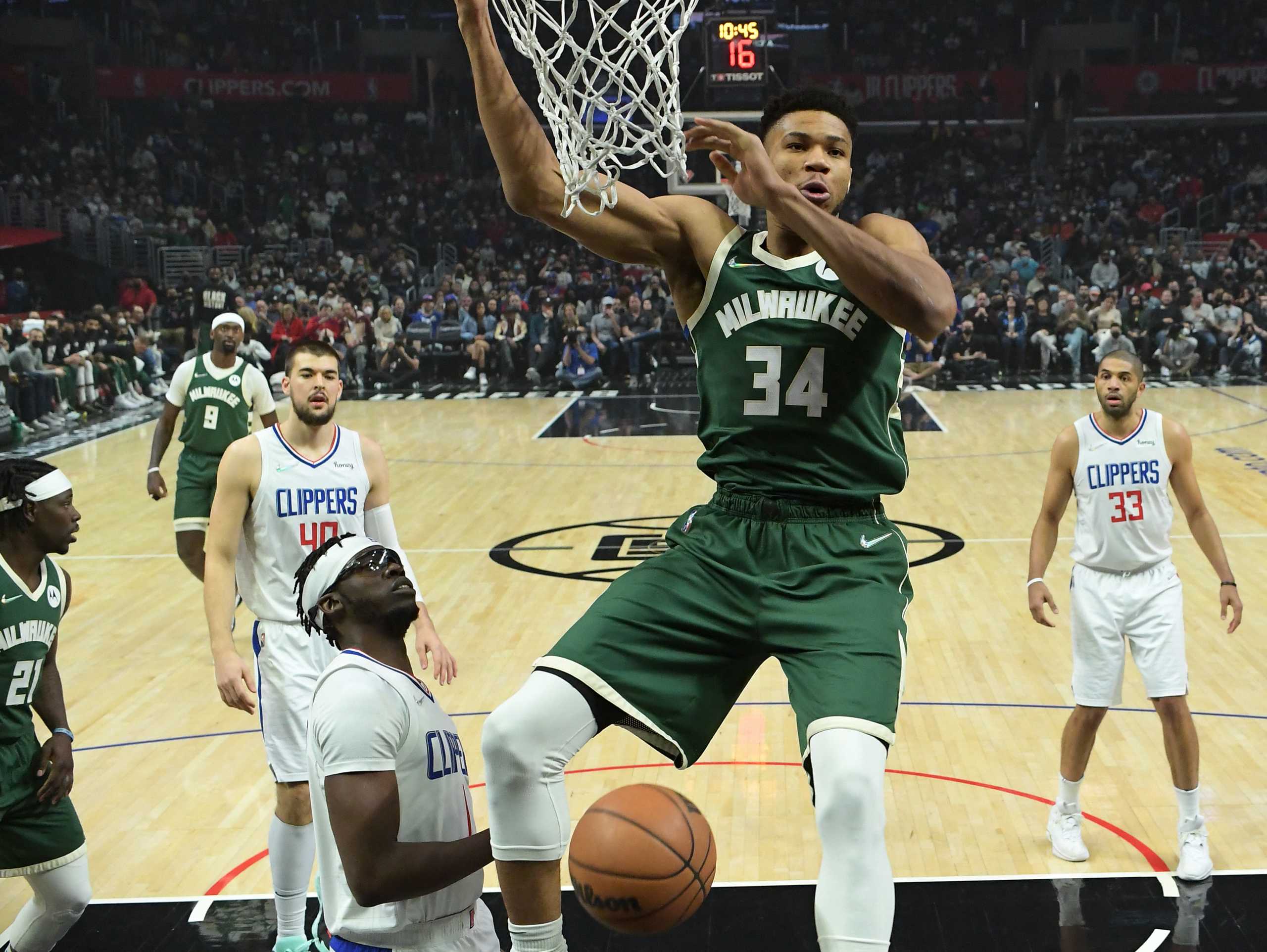 Feb 6, 2022; Los Angeles, California, USA;  Milwaukee Bucks forward Giannis Antetokounmpo (34) gets past Los Angeles Clippers guard Reggie Jackson (1) for a dunk in the first half at Crypto.com Arena. Mandatory Credit: Jayne Kamin-Oncea-USA TODAY Sports