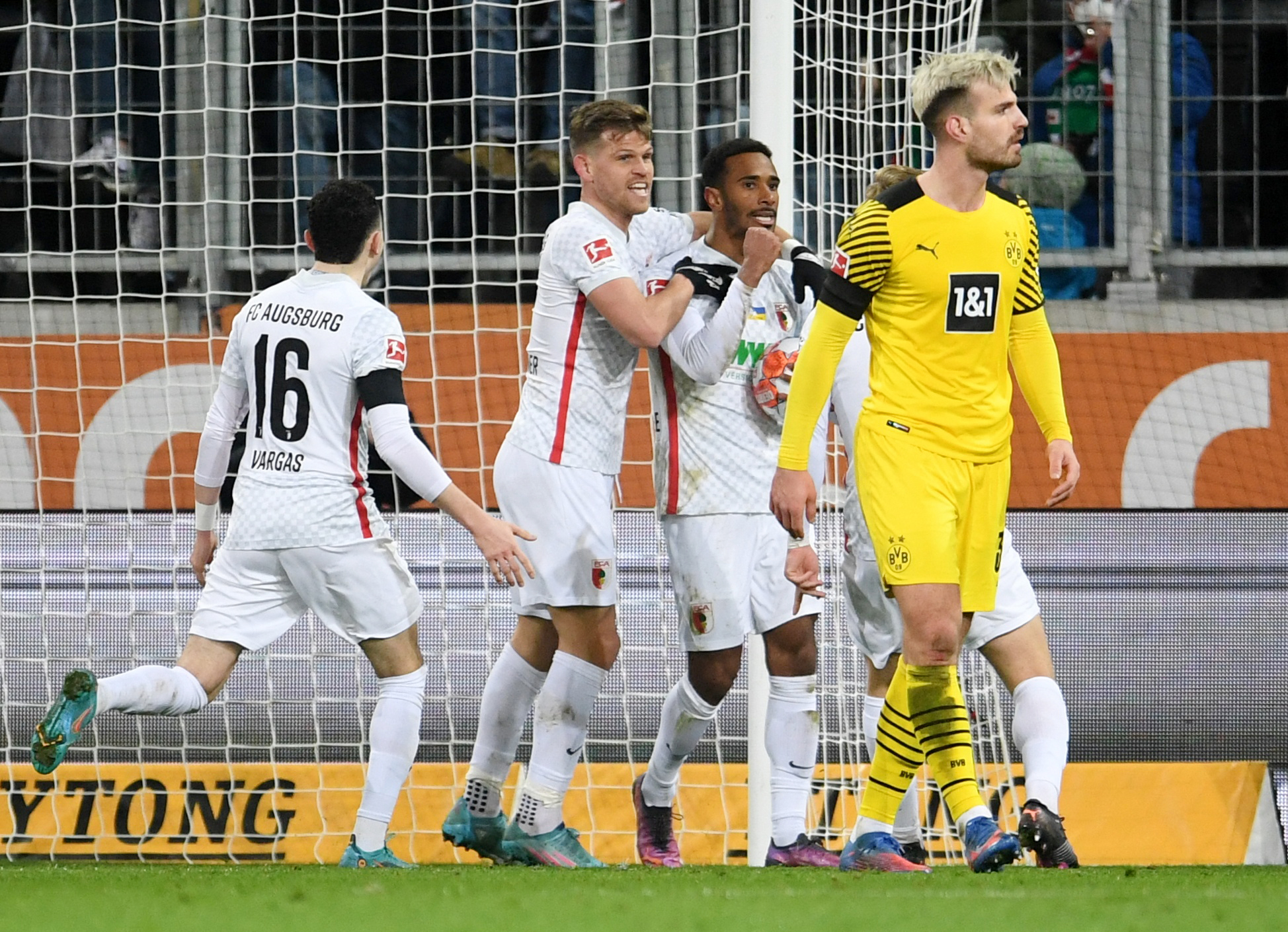 Soccer Football - Bundesliga - FC Augsburg v Borussia Dortmund - WWK Arena, Augsburg, Germany - February  27, 2022 FC Augsburg's Noah Sarenren Bazee celebrates scoring their first goal with teammates REUTERS