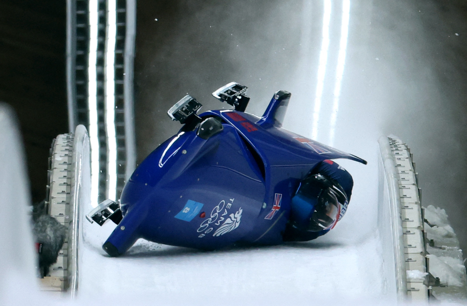 2022 Beijing Olympics - Bobsleigh - 2-man Heat 3 - National Sliding Centre, Beijing, China - February 15, 2022. Brad Hall of Britain and Nick Gleeson of Britain crash during their run. REUTERS