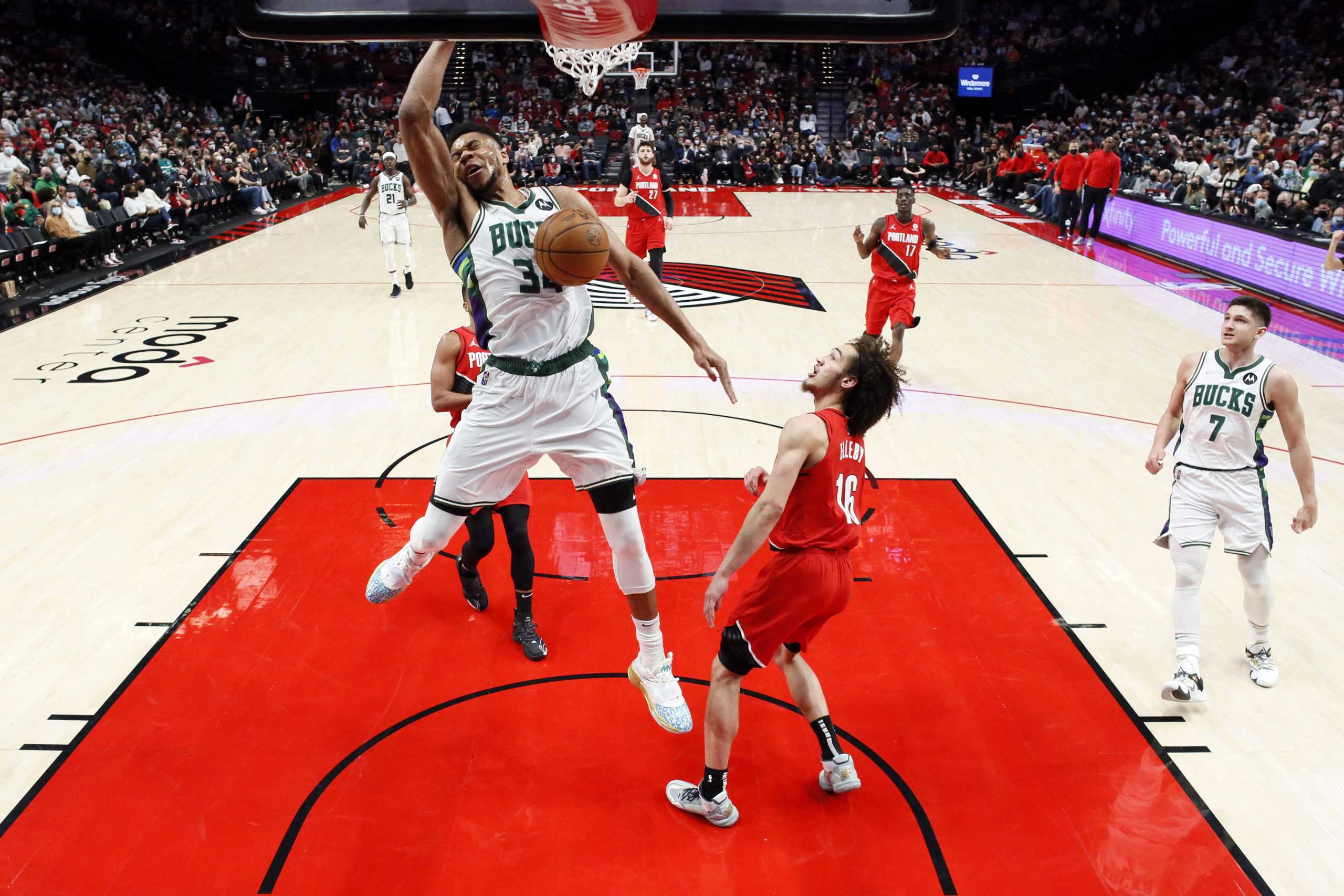 Feb 5, 2022; Portland, Oregon, USA; Milwaukee Bucks power forward Giannis Antetokounmpo (34) dunks against Portland Trail Blazers shooting guard CJ Elleby (16) during the second half at Moda Center. Mandatory Credit: Soobum Im-USA TODAY Sports