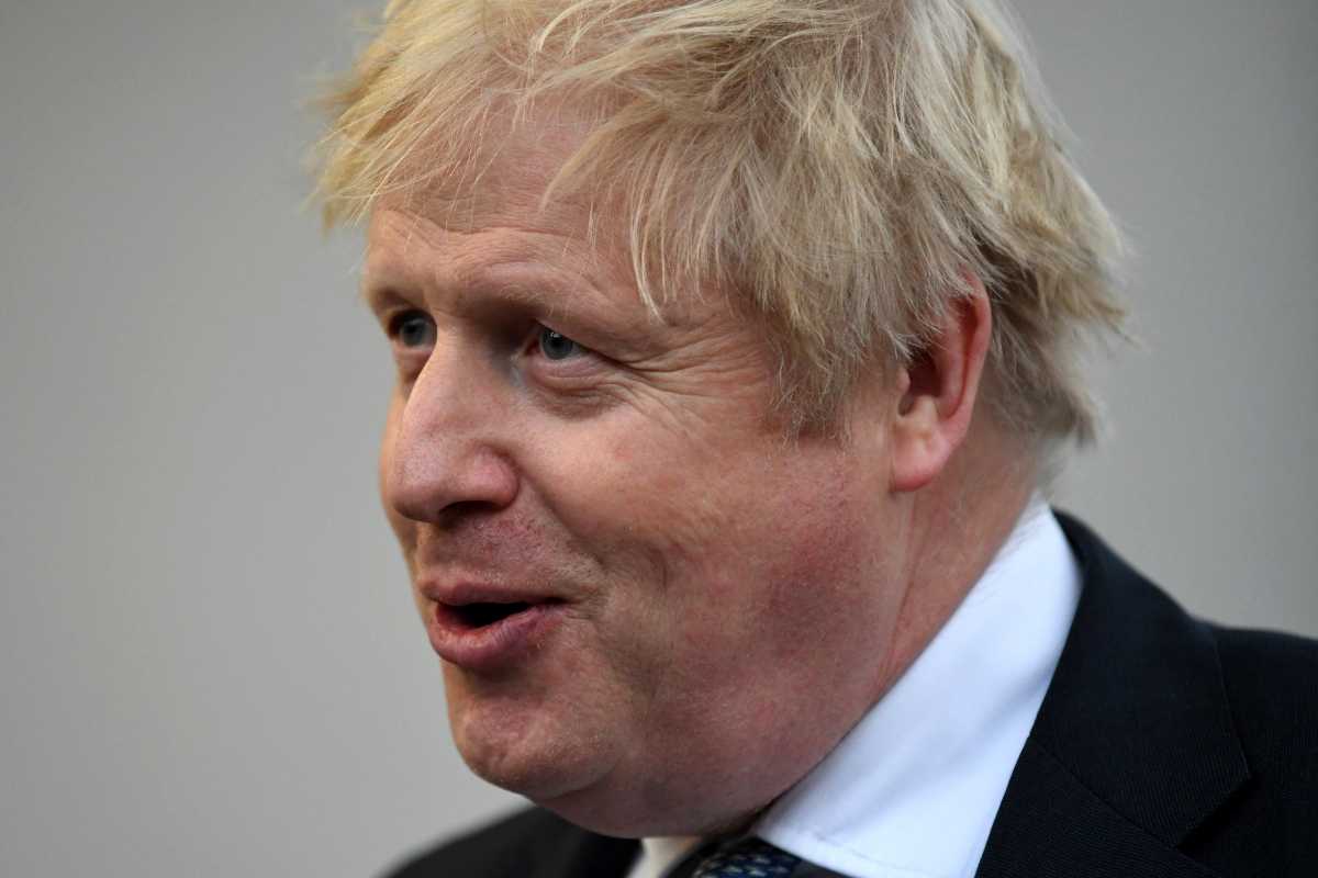 Britain's Prime Minister Boris Johnson speaks with members of the media during a visit to Warszawska Brygada Pancerna military base near Warsaw, Poland February 10, 2022. Daniel Leal