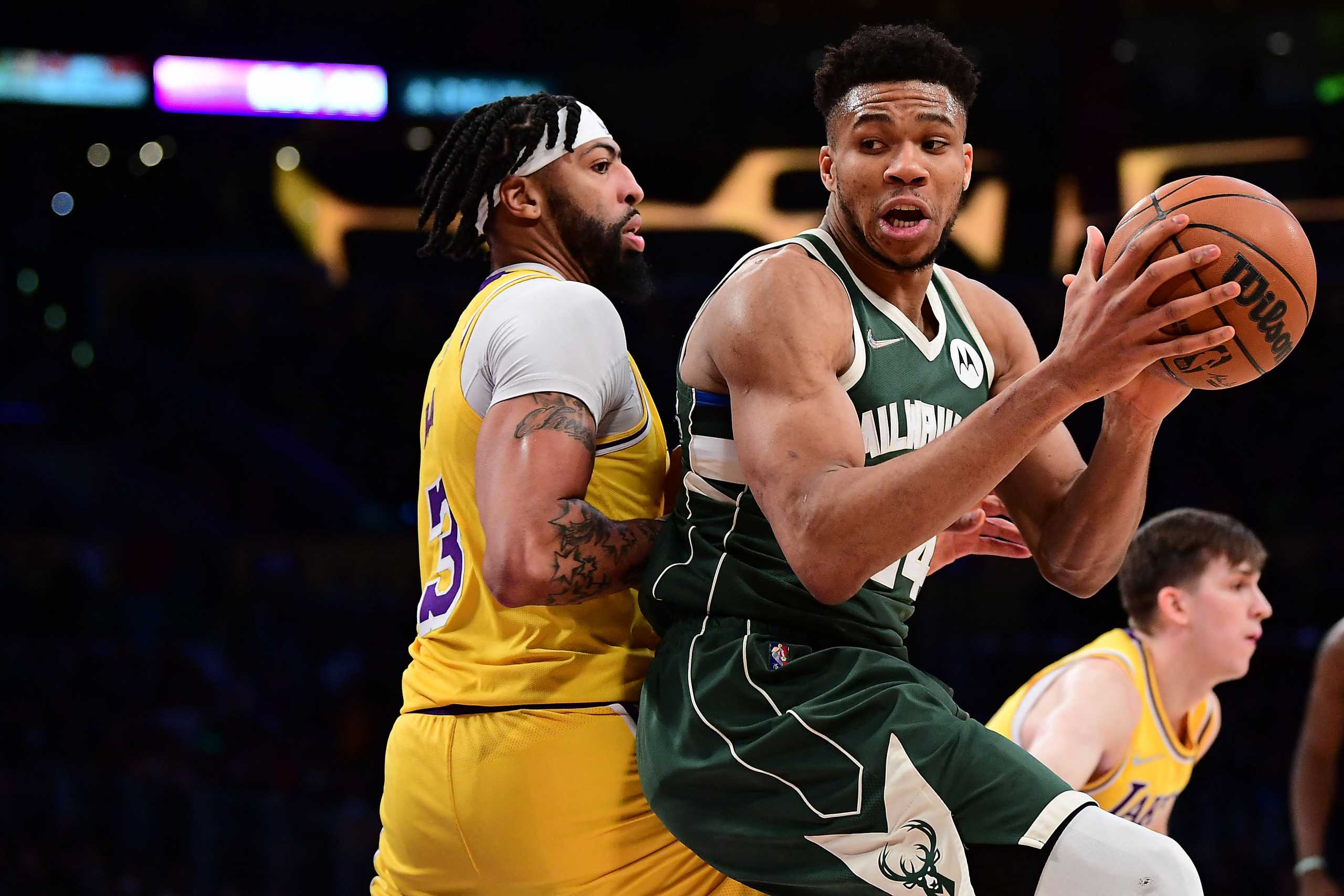 Feb 8, 2022; Los Angeles, California, USA; Milwaukee Bucks forward Giannis Antetokounmpo (34) moves the ball against Los Angeles Lakers forward Anthony Davis (3) during the second half at Crypto.com Arena. Mandatory Credit: Gary A. Vasquez-USA TODAY Sports