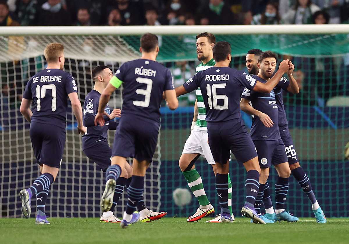Soccer Football - Champions League - Round of 16 First Leg - Sporting CP v Manchester City - Estadio Jose Alvalade, Lisbon, Portugal - February 15, 2022 Manchester City's Riyad Mahrez celebrates scoring their first goal with teammates Action Images via Reuters