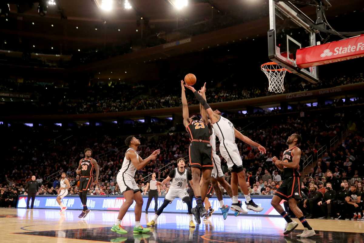 Feb 16, 2022; New York, New York, USA; New York Knicks center Mitchell Robinson (23) fights for a rebound against Brooklyn Nets center LaMarcus Aldridge (21) and forward James Johnson (16) during the fourth quarter at Madison Square Garden. Mandatory Credit: Brad Penner-USA TODAY Sports
