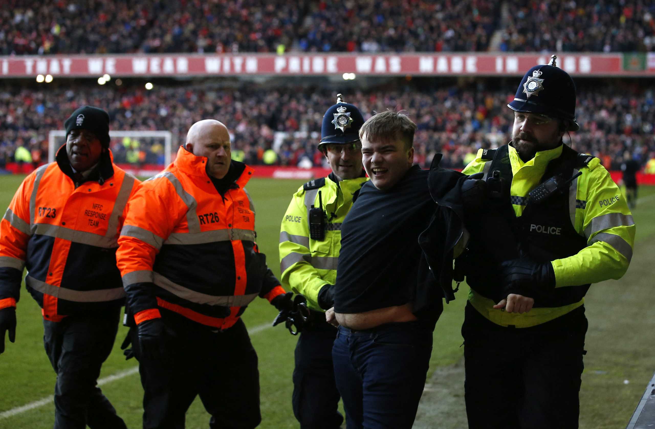 Soccer Football - FA Cup - Fourth Round - Nottingham Forest v Leicester City - The City Ground, Nottingham, Britain - February 6, 2022 A Leicester City fan is arrested by police after invading the pitch REUTERS