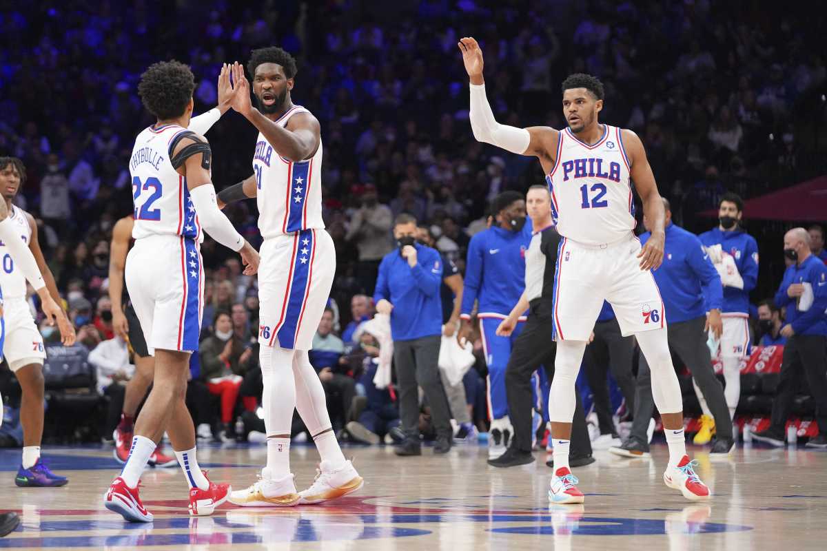 Feb 12, 2022; Philadelphia, Pennsylvania, USA; Philadelphia 76ers guard Matisse Thybulle (22), center Joel Embiid (21), and forward Tobias Harris (12) react against the Cleveland Cavaliers in the first half at the Wells Fargo Center. Mandatory Credit: Mitchell Leff-USA TODAY Sports