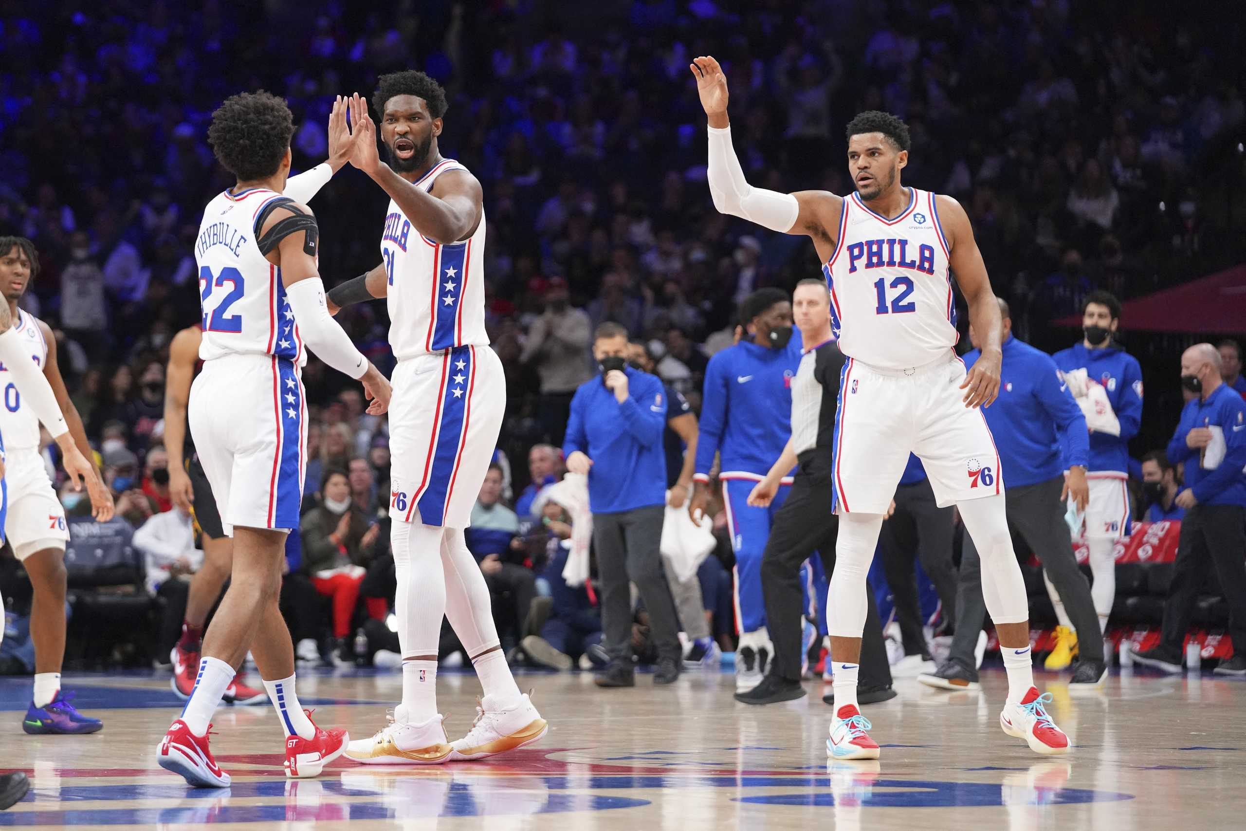 Feb 12, 2022; Philadelphia, Pennsylvania, USA; Philadelphia 76ers guard Matisse Thybulle (22), center Joel Embiid (21), and forward Tobias Harris (12) react against the Cleveland Cavaliers in the first half at the Wells Fargo Center. Mandatory Credit: Mitchell Leff-USA TODAY Sports