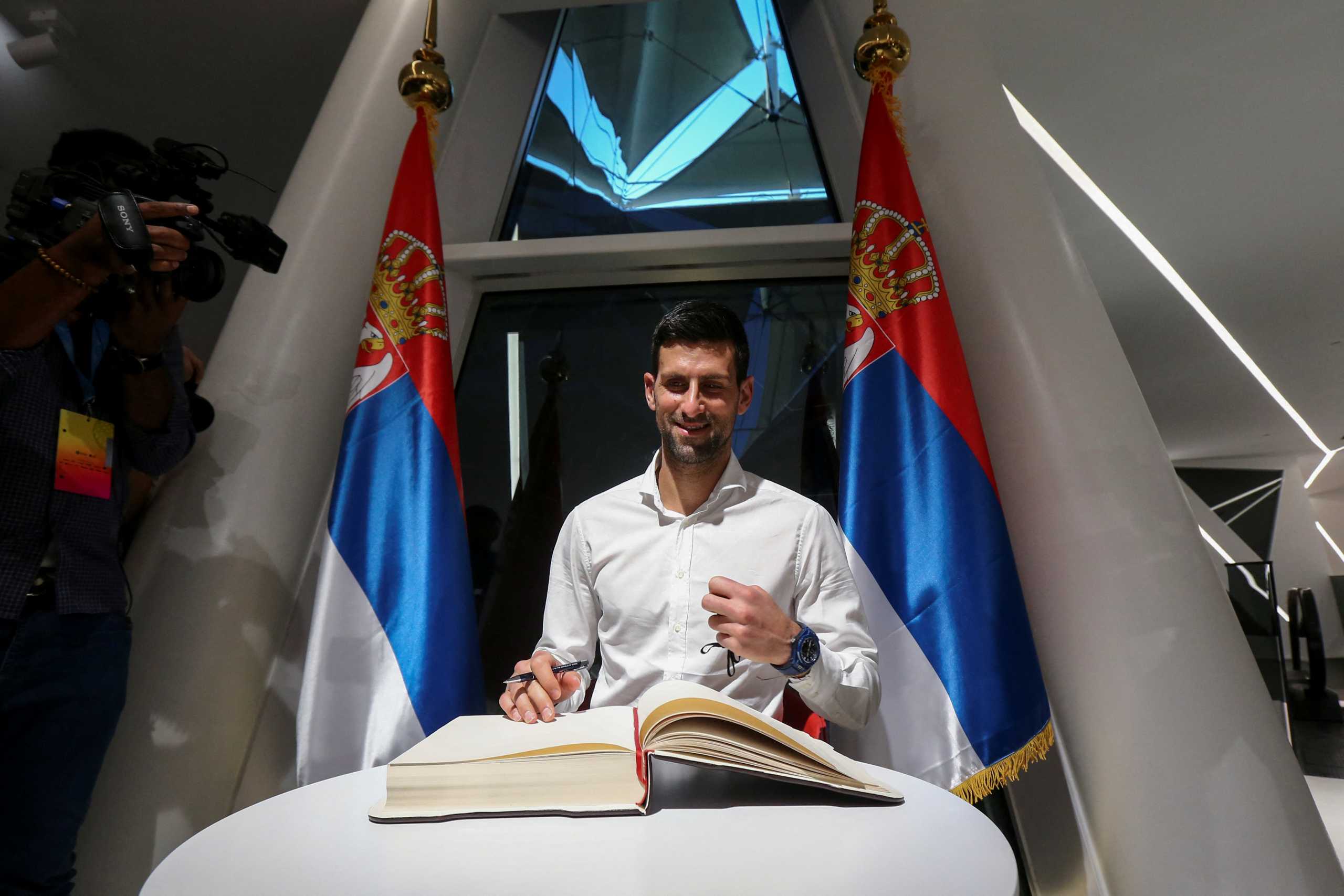 Tennis player Novak Djokovic signs the honour book as he visits the Serbia pavilion at Expo 2020 for the presentation of the Novak Djokovic Foundation, in Dubai, United Arab Emirates, February 17, 2022. REUTERS