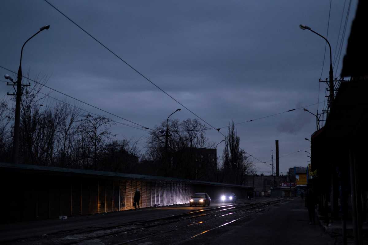 A woman walks along an empty street the day after Moscow's decision to formally recognize two Russian-backed regions of eastern Ukraine as independent, at city of Mariupol, located about 20 kilometers from the rebel-controlled areas in eastern Ukraine, February 22, 2022. REUTERS
