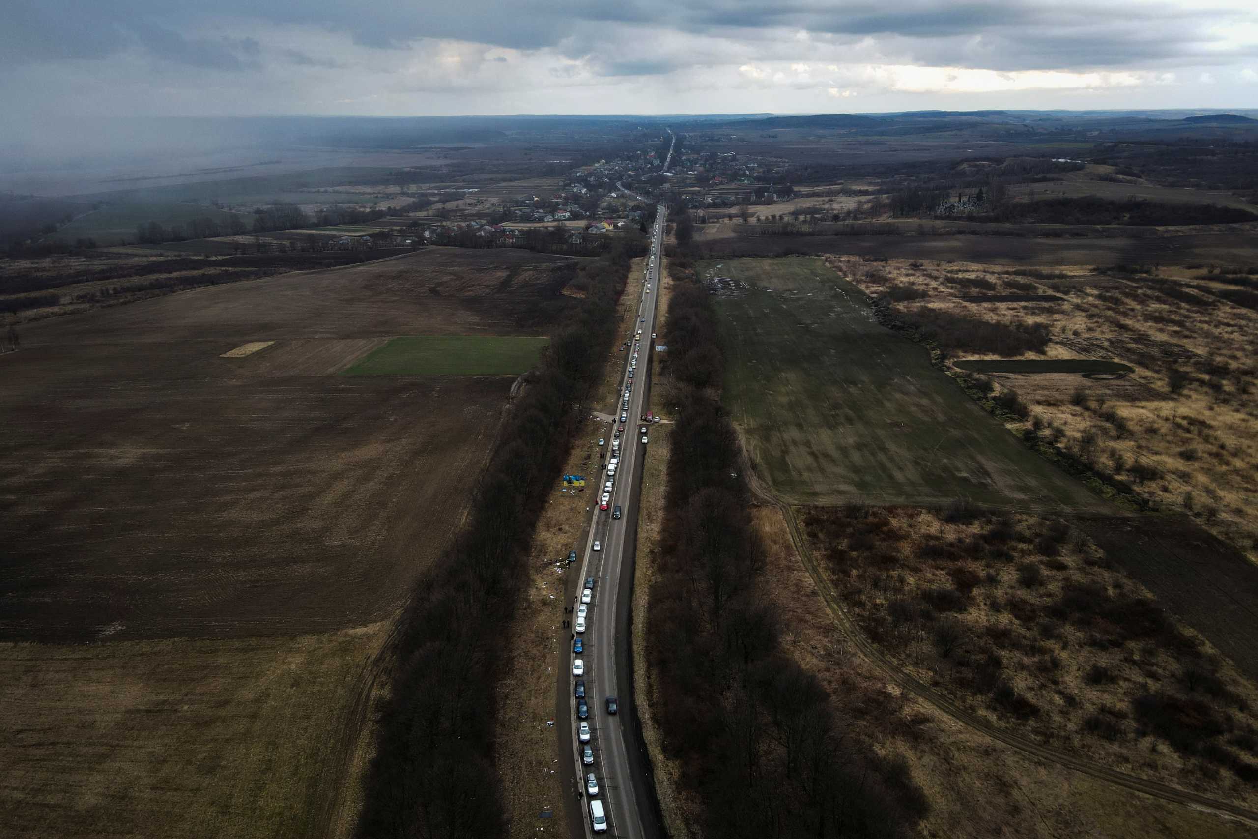 Cars line up on the road to the Shehyni border crossing as people flee to Poland, after Russia launched a massive military operation against Ukraine, outside Mostyska, Ukraine, February 27, 2022. Picture taken with a drone.  REUTERS