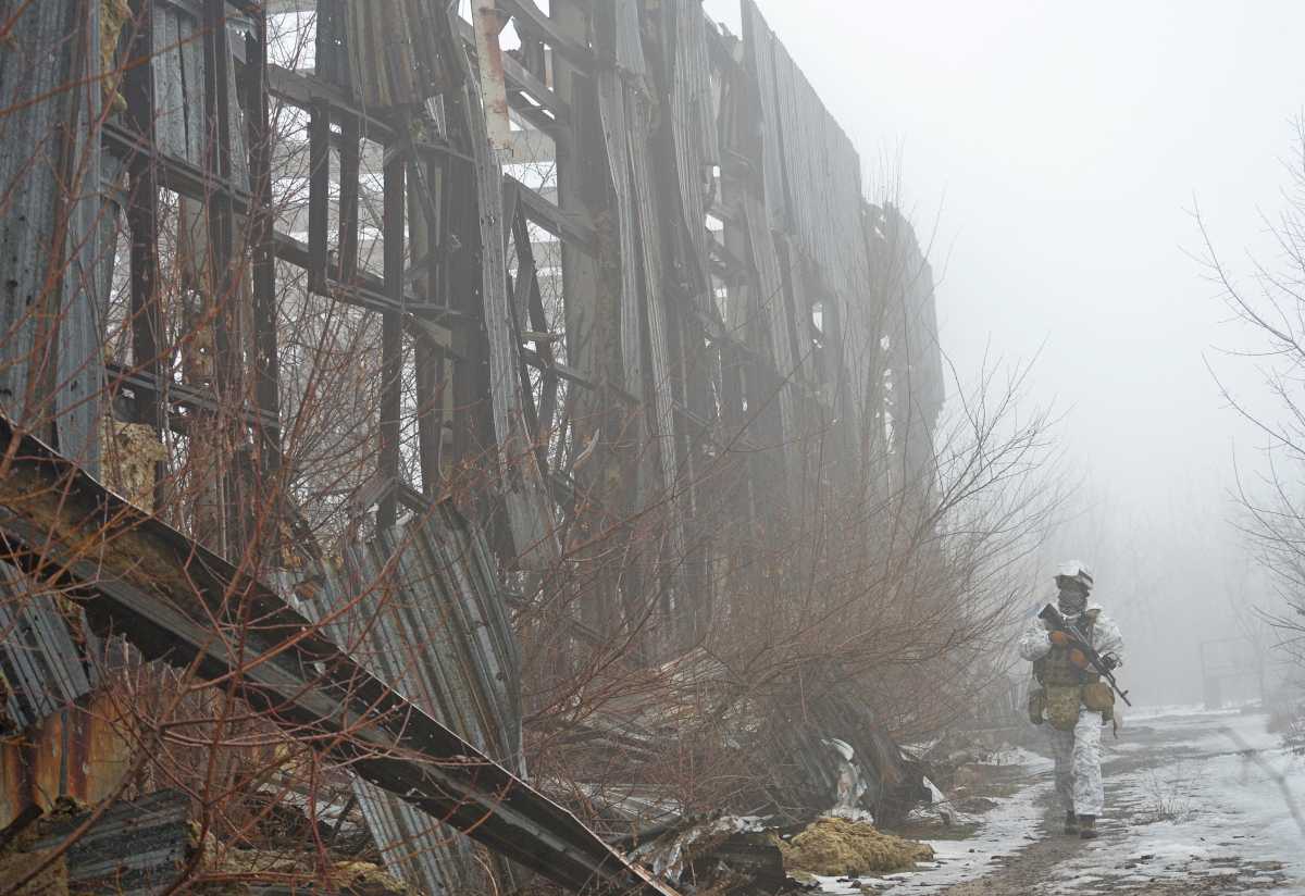 A service member of the Ukrainian armed forces walks at combat positions near the line of separation from Russian-backed rebels outside the town of Avdiivka in the Donetsk Region, Ukraine February 11, 2022. REUTERS
