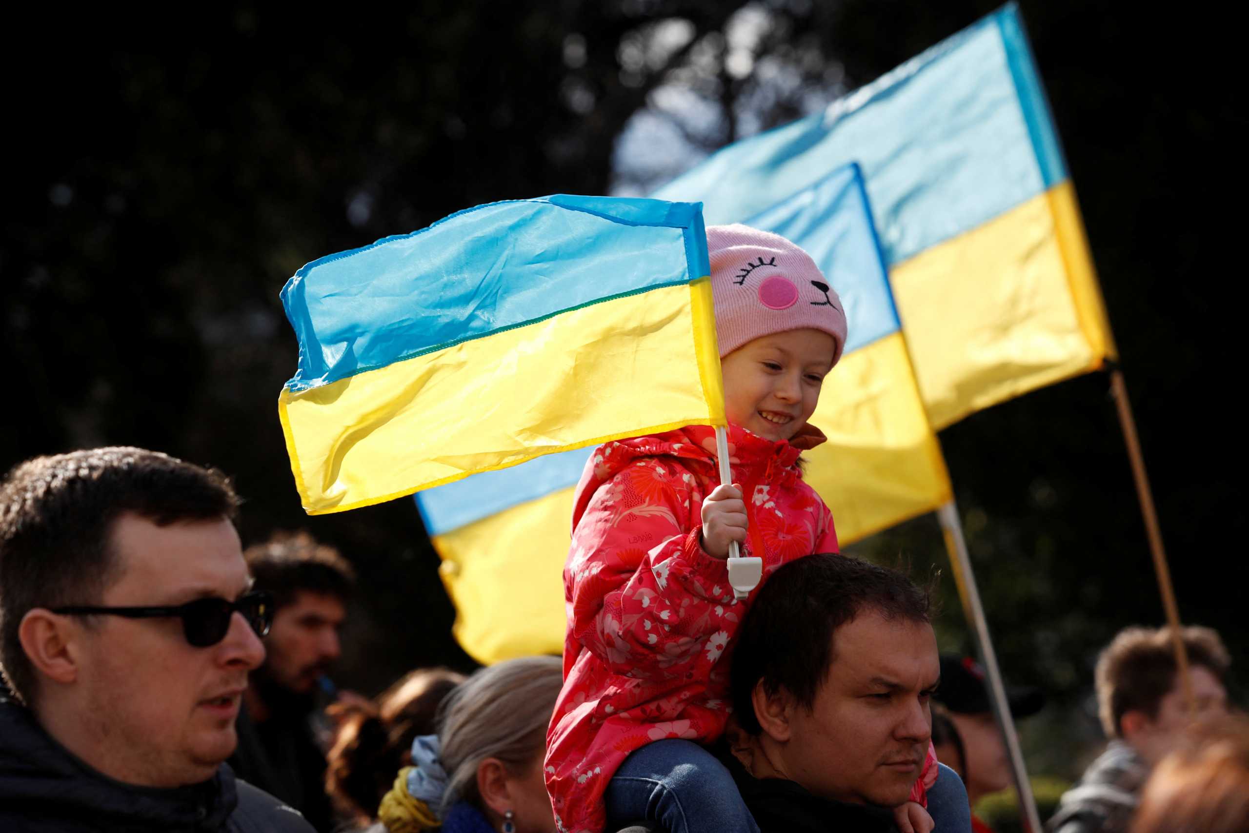 A girl holds a Ukrainian flag during an anti-war protest march, after Russia launched a massive military operation against Ukraine, in Podgorica, Montenegro February 27, 2022. REUTERS