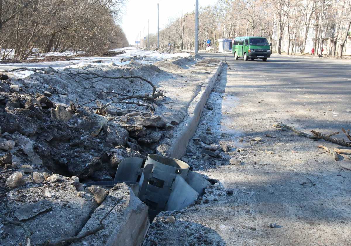 A rocket case lies buried into a road after recent shelling in Kharkiv, Ukraine February 24, 2022.  REUTERS
