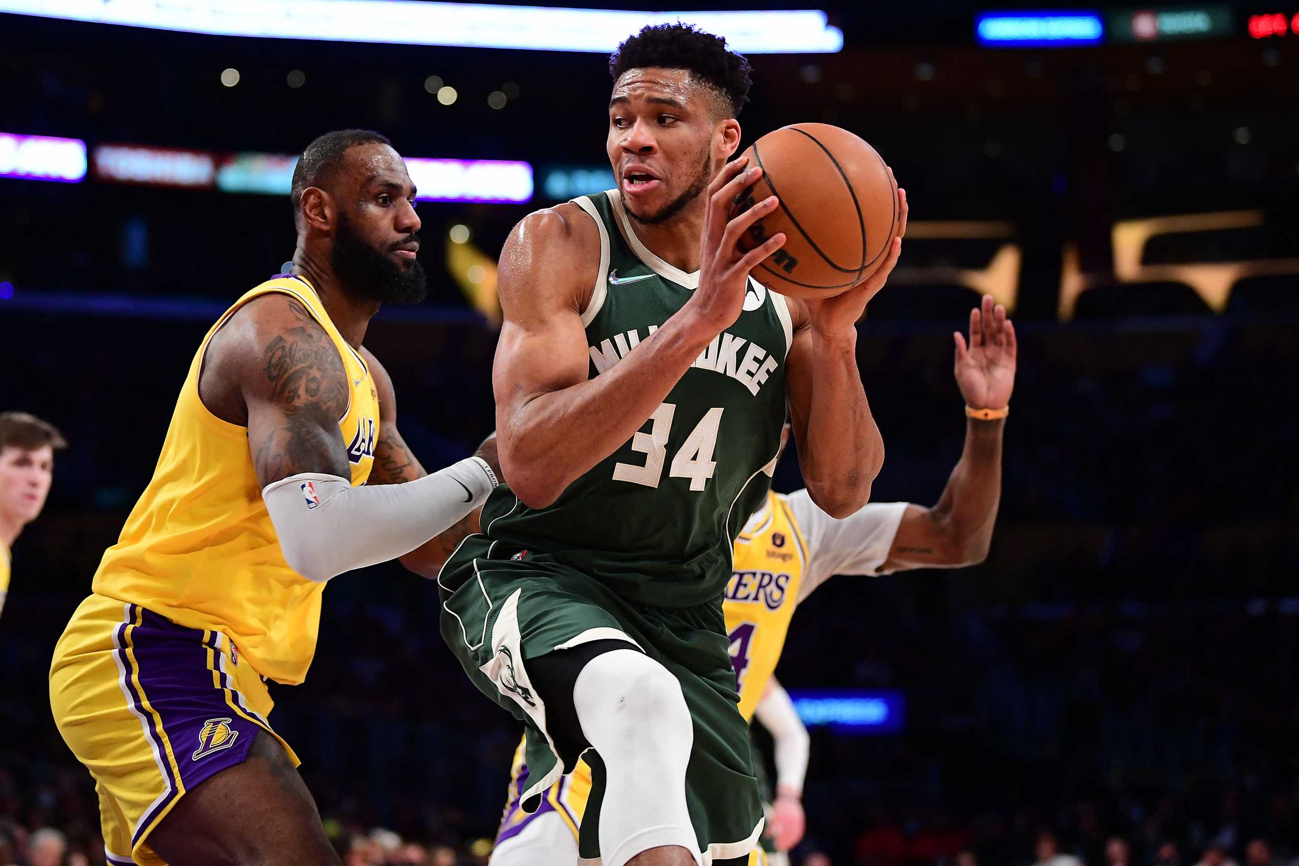 Feb 8, 2022; Los Angeles, California, USA; Milwaukee Bucks forward Giannis Antetokounmpo (34) moves the ball against Los Angeles Lakers forward LeBron James (6) during the second half at Crypto.com Arena. Mandatory Credit: Gary A. Vasquez-USA TODAY Sports