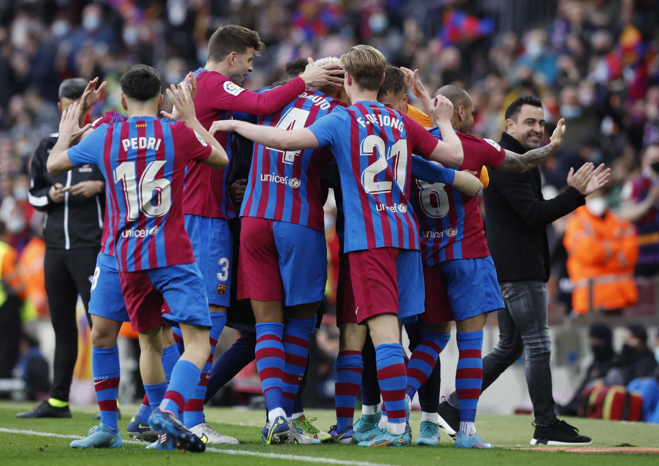 Soccer Football - LaLiga - FC Barcelona v Atletico Madrid - Camp Nou, Barcelona, Spain - February 6, 2022 FC Barcelona's Dani Alves celebrates scoring their fourth goal with teammates and coach Xavi REUTERS