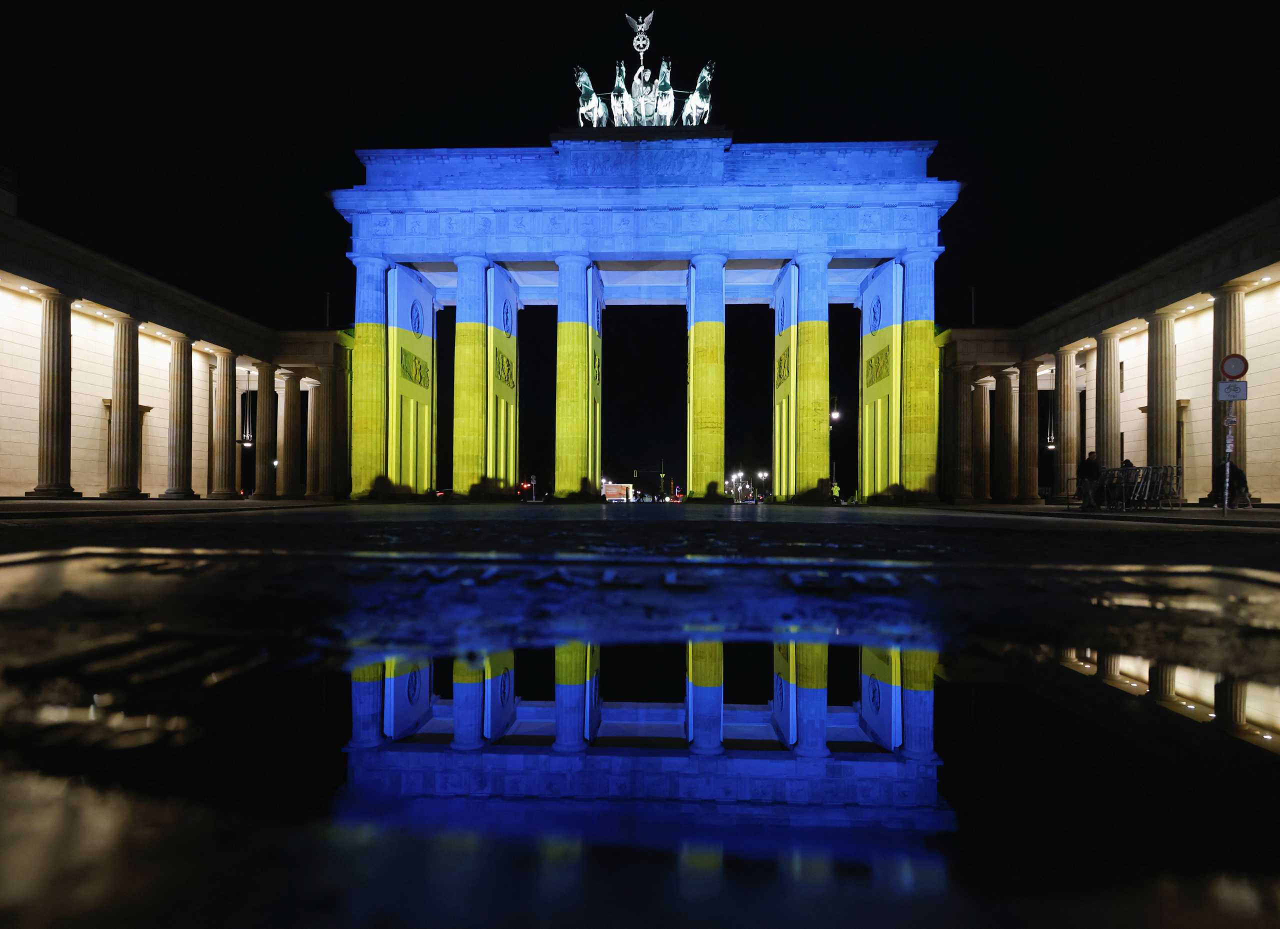The Brandenburg Gate is illuminated in Ukrainian national colors, in Berlin, Germany February 23, 2022. REUTERS