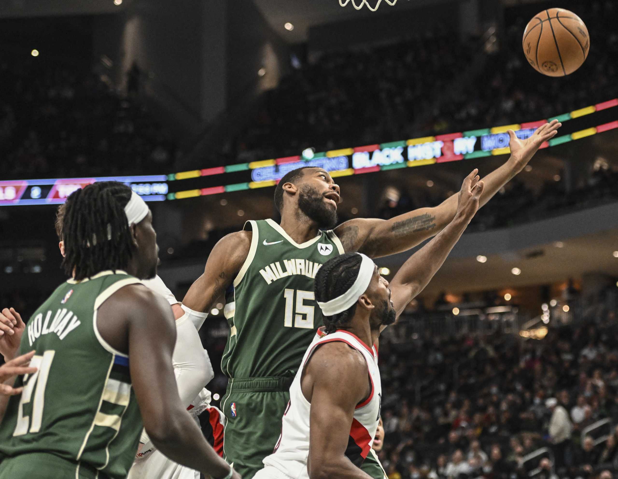 Feb 14, 2022; Milwaukee, Wisconsin, USA;  Milwaukee Bucks center Greg Monroe (15) and Portland Trail Blazers guard Justise Winslow (16) reach for a rebound in the second quarter at Fiserv Forum. Mandatory Credit: Benny Sieu-USA TODAY Sports