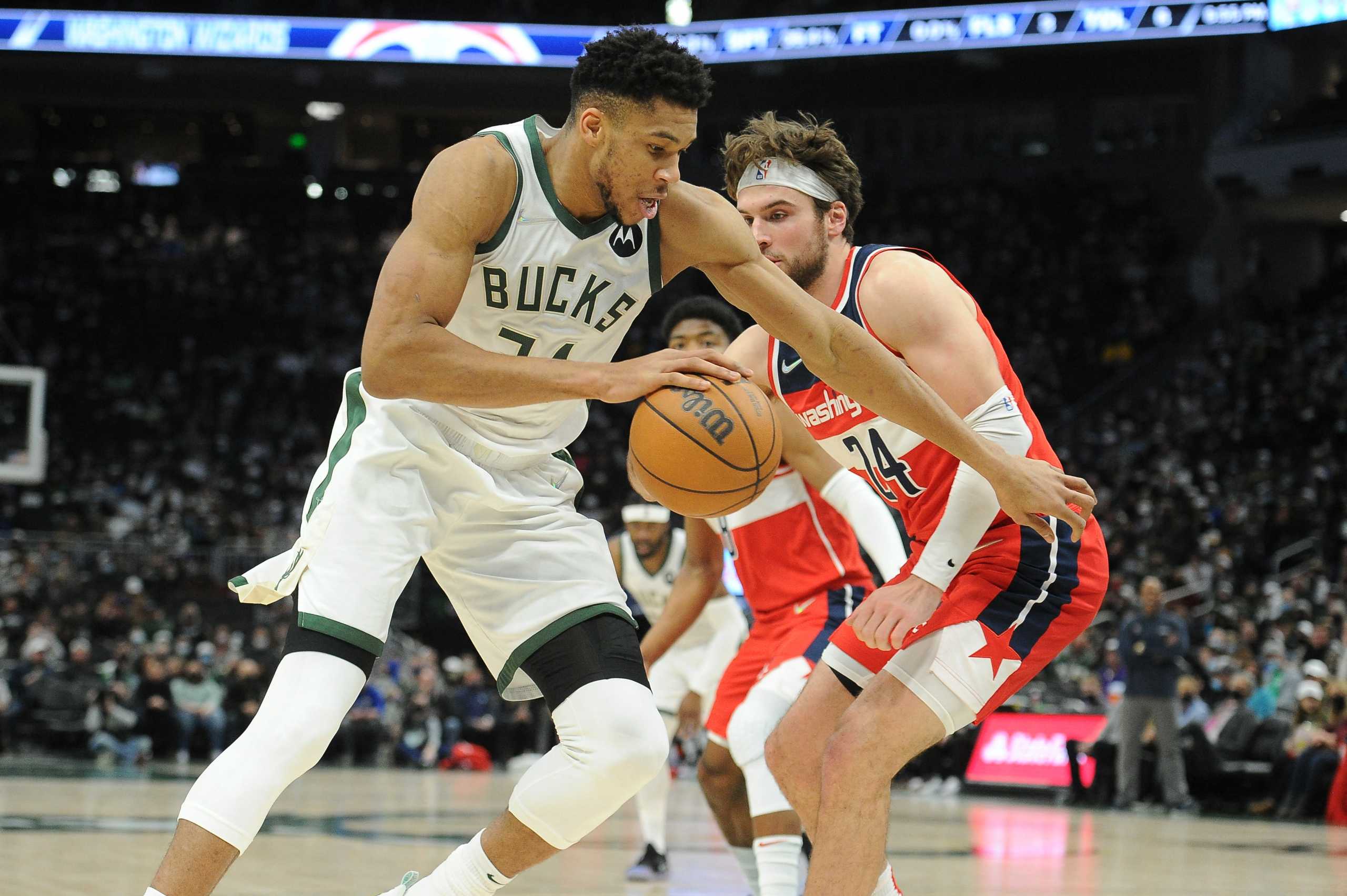 Feb 1, 2022; Milwaukee, Wisconsin, USA;  Milwaukee Bucks forward Giannis Antetokounmpo (34) drives the baseline against Washington Wizards forward Corey Kispert (24) in the first half at Fiserv Forum. Mandatory Credit: Michael McLoone-USA TODAY Sports