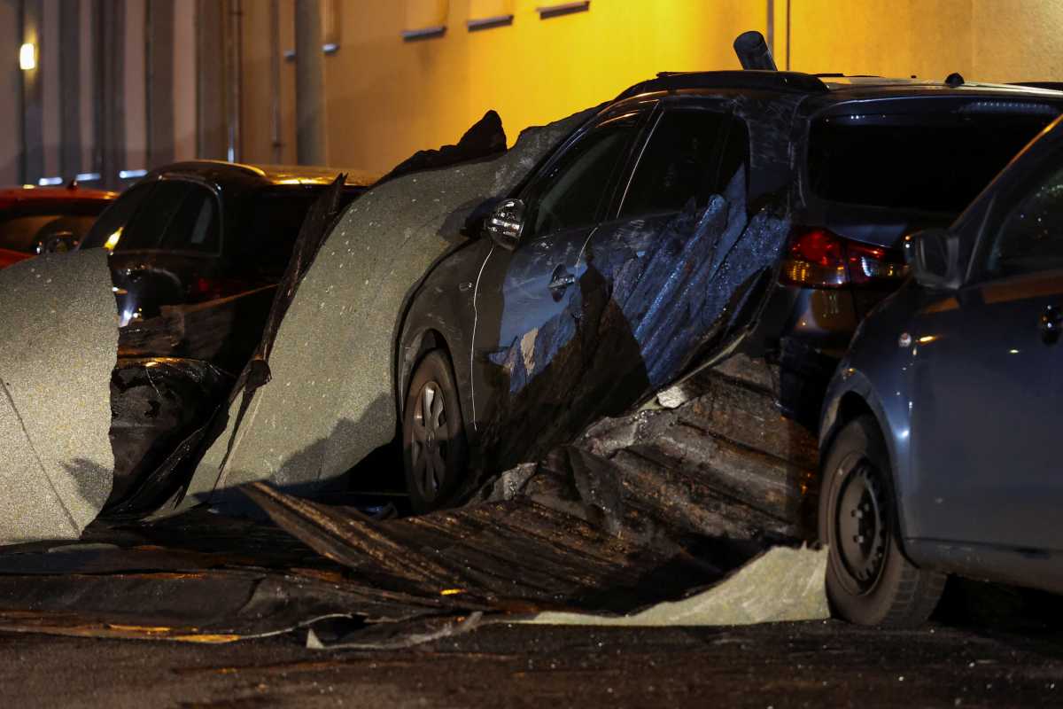 Cars damaged by debris from a roof are seen following heavy storms in Berlin, Germany, February 19, 2022. REUTERS