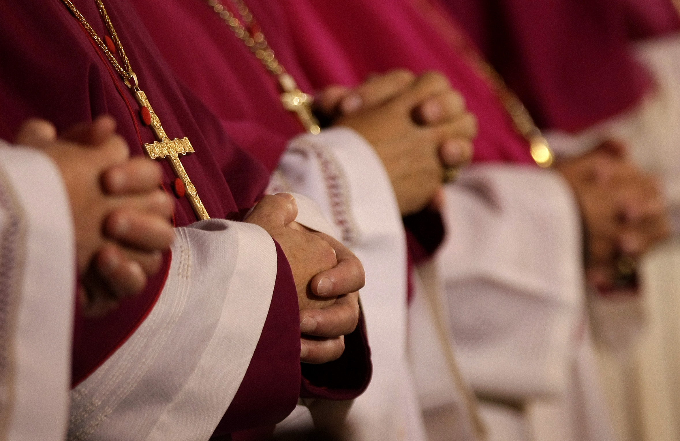 German bishops fold their hands in prayers during a service to open the annual bishop's conference in Fulda, September 25, 2007.    REUTERS