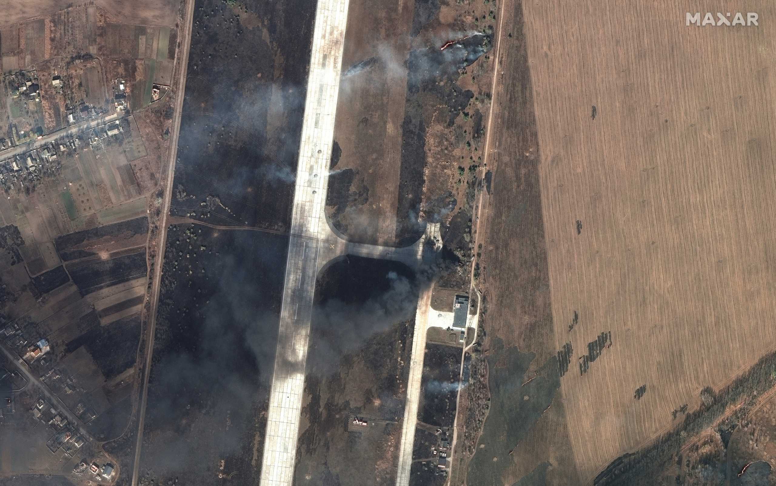 A satellite image shows grass fires and damages at Antonov Airport in Hostomel, Ukraine, February 27, 2022. Satellite image ©2022 Maxar Technologies