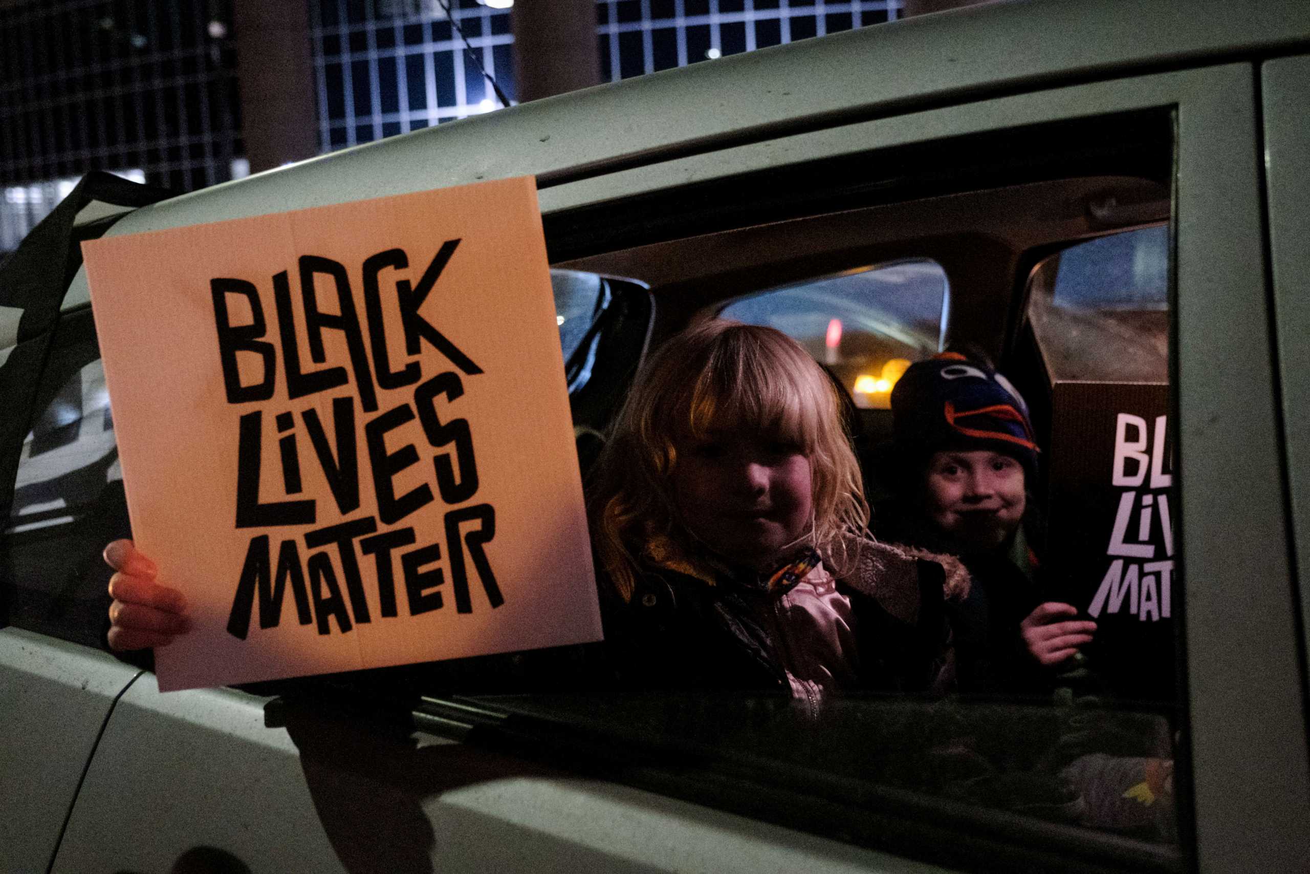 FILE PHOTO: Children hold up Black Lives Matter signs during a protest for Amir Locke, a Black man who was shot and killed by Minneapolis police’s SWAT team, in Minneapolis, Minnesota, U.S., February 4, 2022. REUTERS
