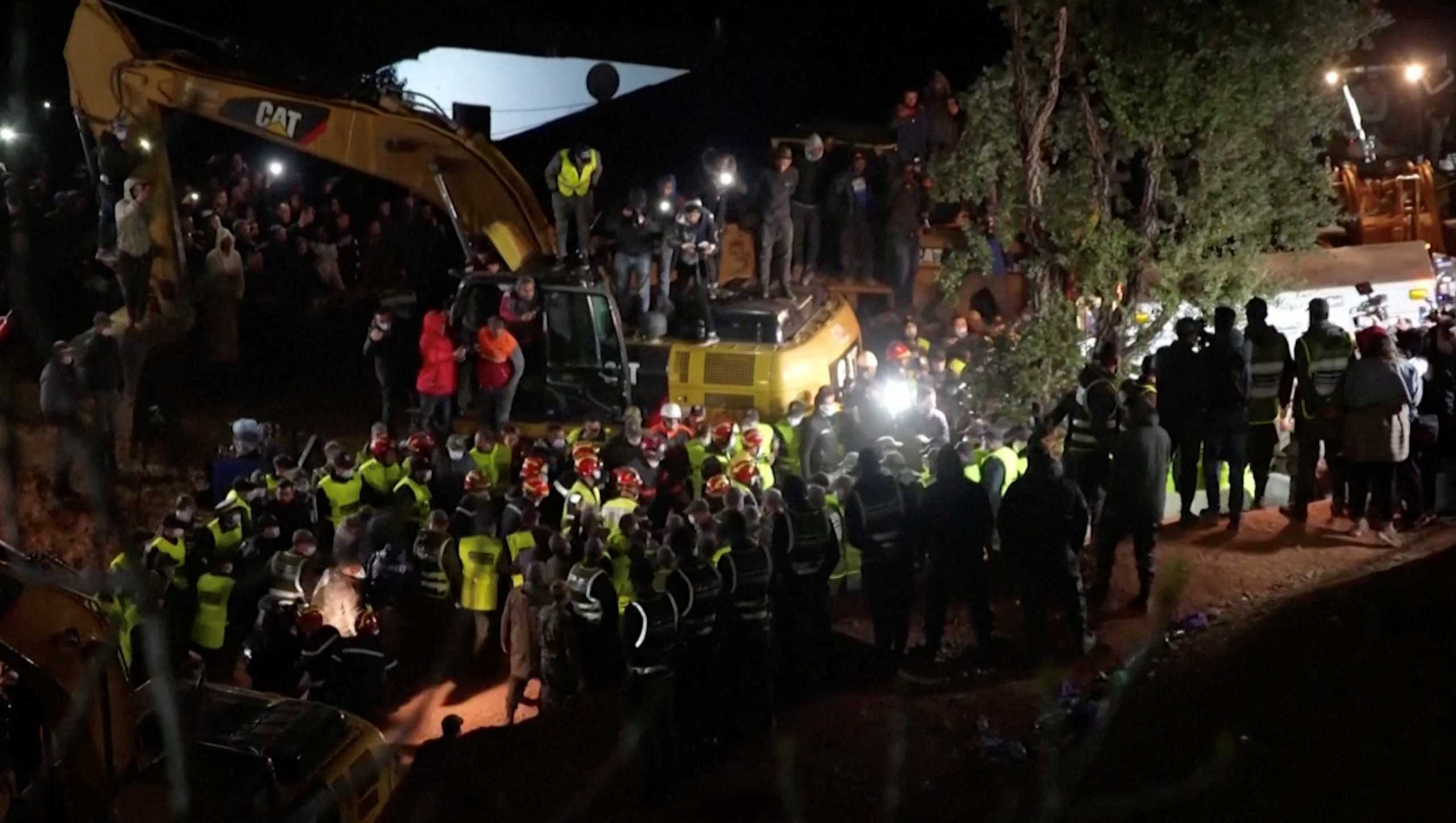 Rescue workers carry the body of child 5-year-old Rayan Awram, who had been trapped for five days in a well, to an ambulance, near Chefchaouen, northern Morocco February 5, 2022, in this screen grab taken from a video. REUTERS TV
