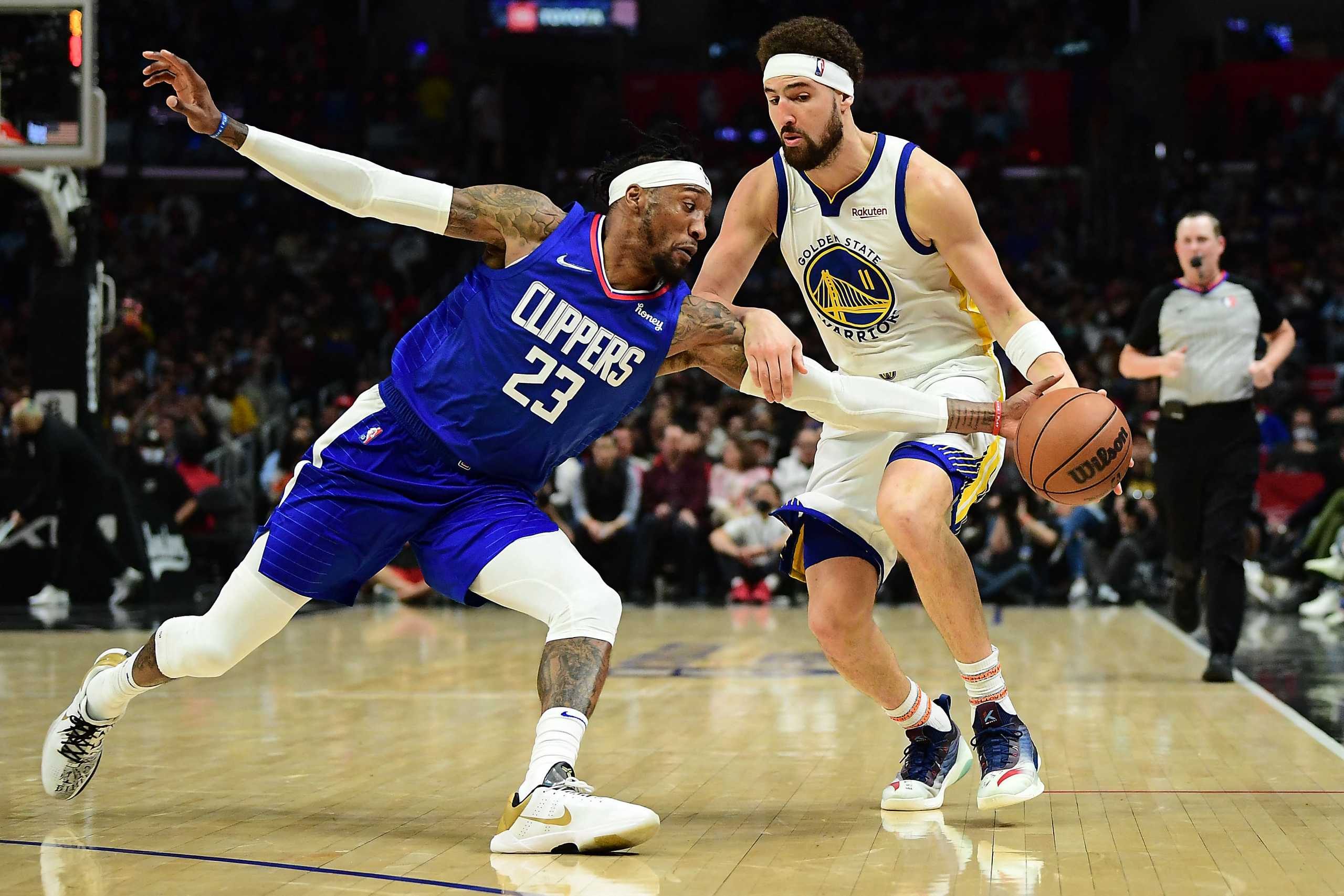 Feb 14, 2022; Los Angeles, California, USA; Los Angeles Clippers forward Robert Covington (23) plays for the ball against Golden State Warriors guard Klay Thompson (11) during the second half at Crypto.com Arena. Mandatory Credit: Gary A. Vasquez-USA TODAY Sports