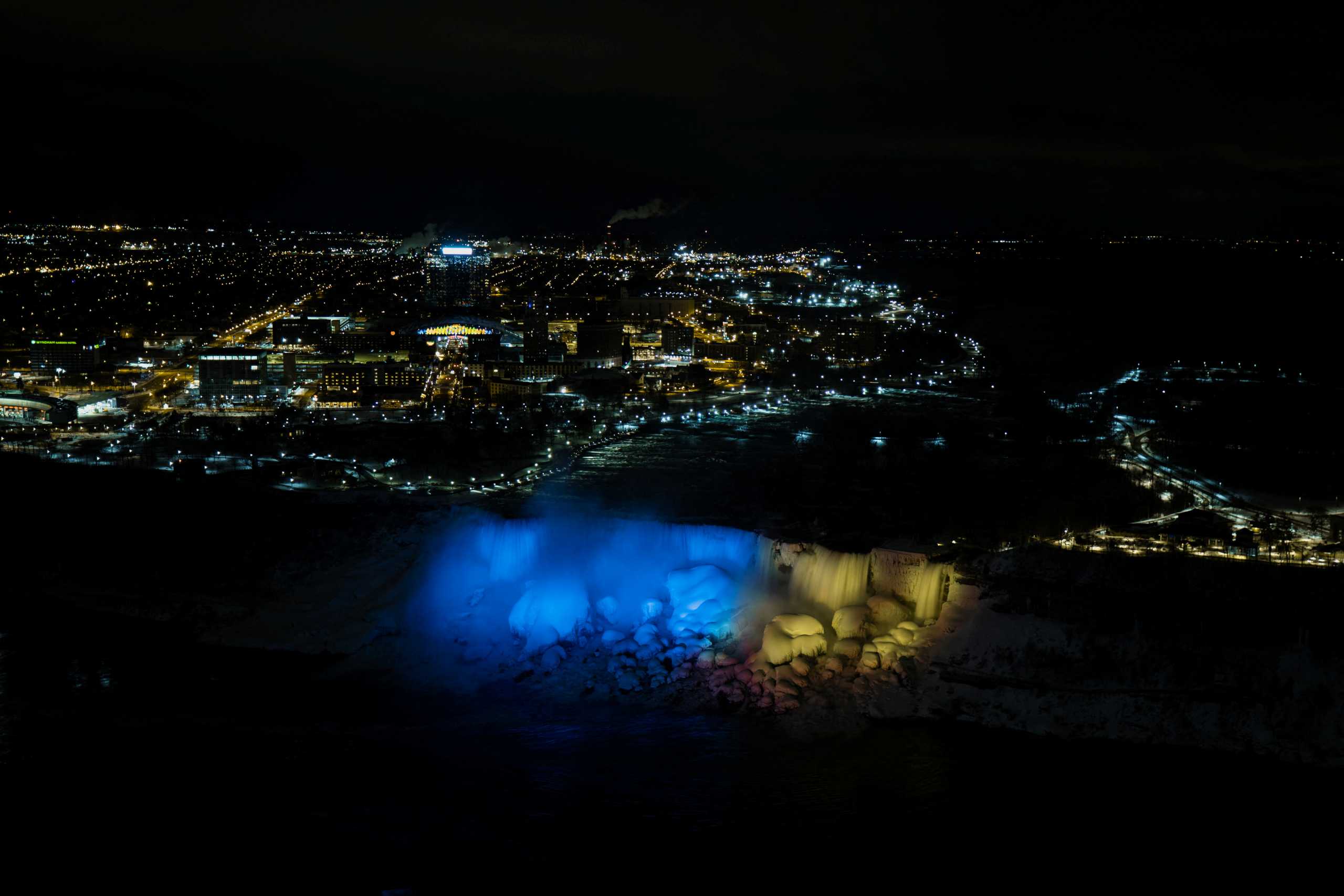 The American Falls and Bridal Veil Falls are lit in the colours of the Ukrainian flag, following the Russian invasion in Ukraine, as seen from Niagara Falls, Ontario, Canada February 27, 2022.  REUTERS