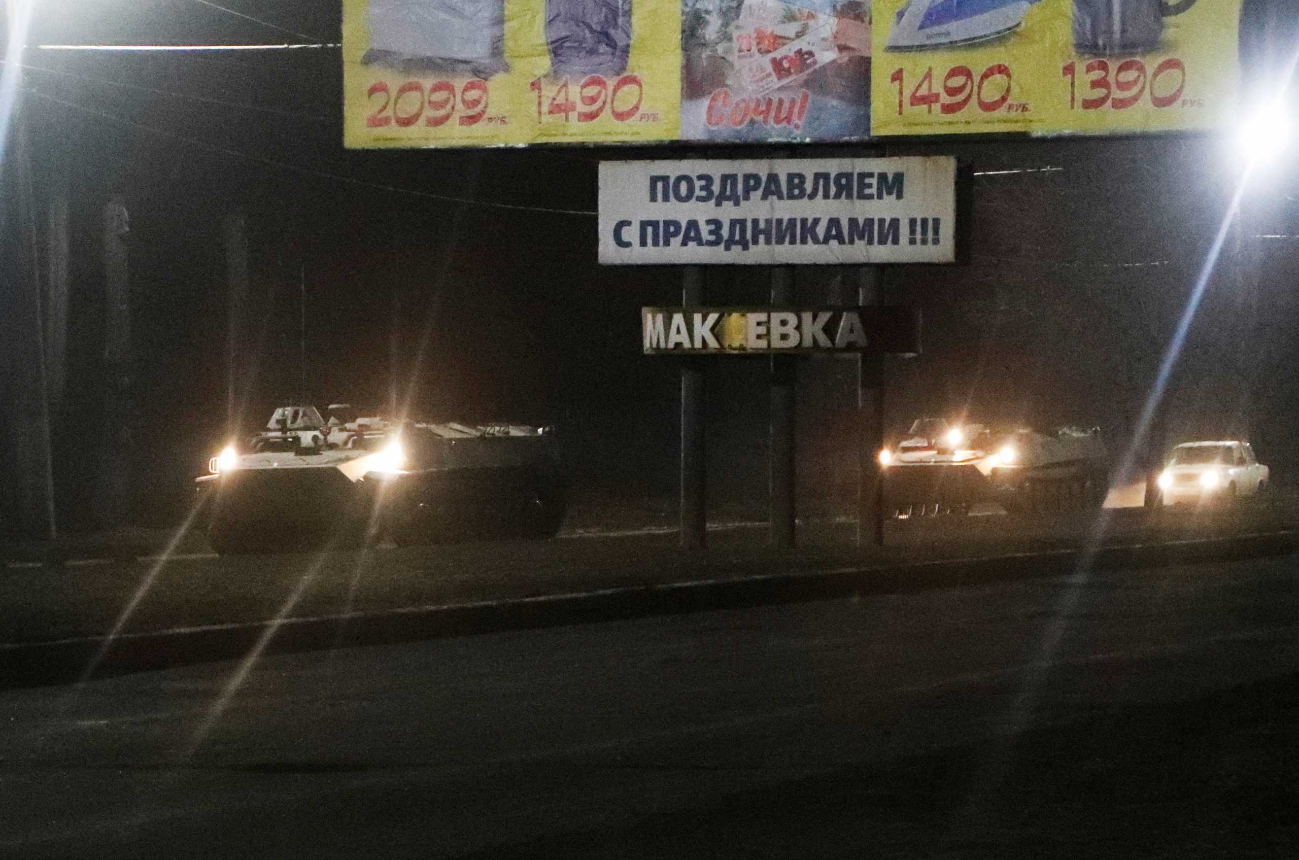 Military vehicles drive along a street after Russian President Vladimir Putin ordered the deployment of Russian troops to two breakaway regions in eastern Ukraine following the recognition of their independence, in the separatist-controlled city of Donetsk, Ukraine February 22, 2022. REUTERS