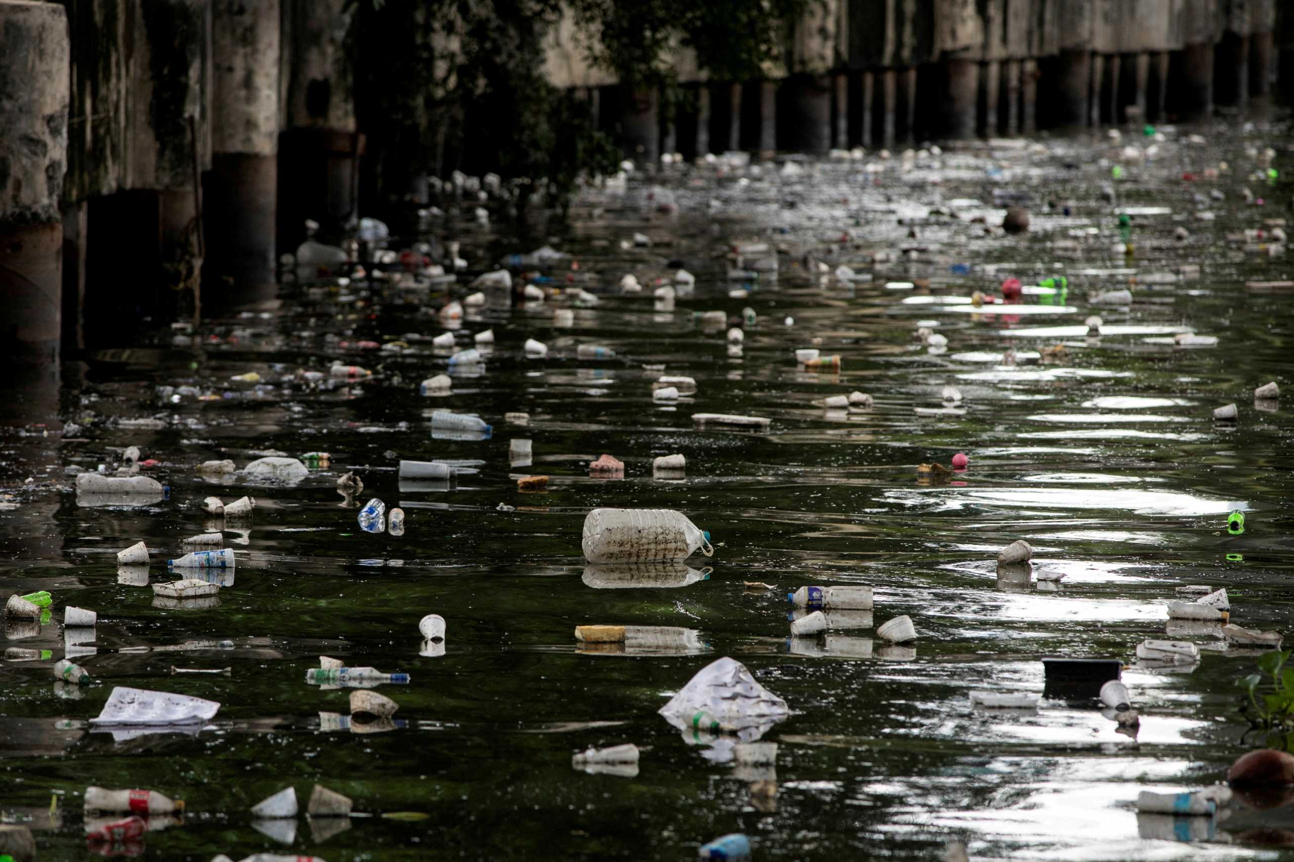 FILE PHOTO: Plastic bottles float on the heavily polluted San Juan River, a tributary of Pasig River in Mandaluyong City, Philippines, June 21, 2021. Picture taken June 21, 2021. REUTERS