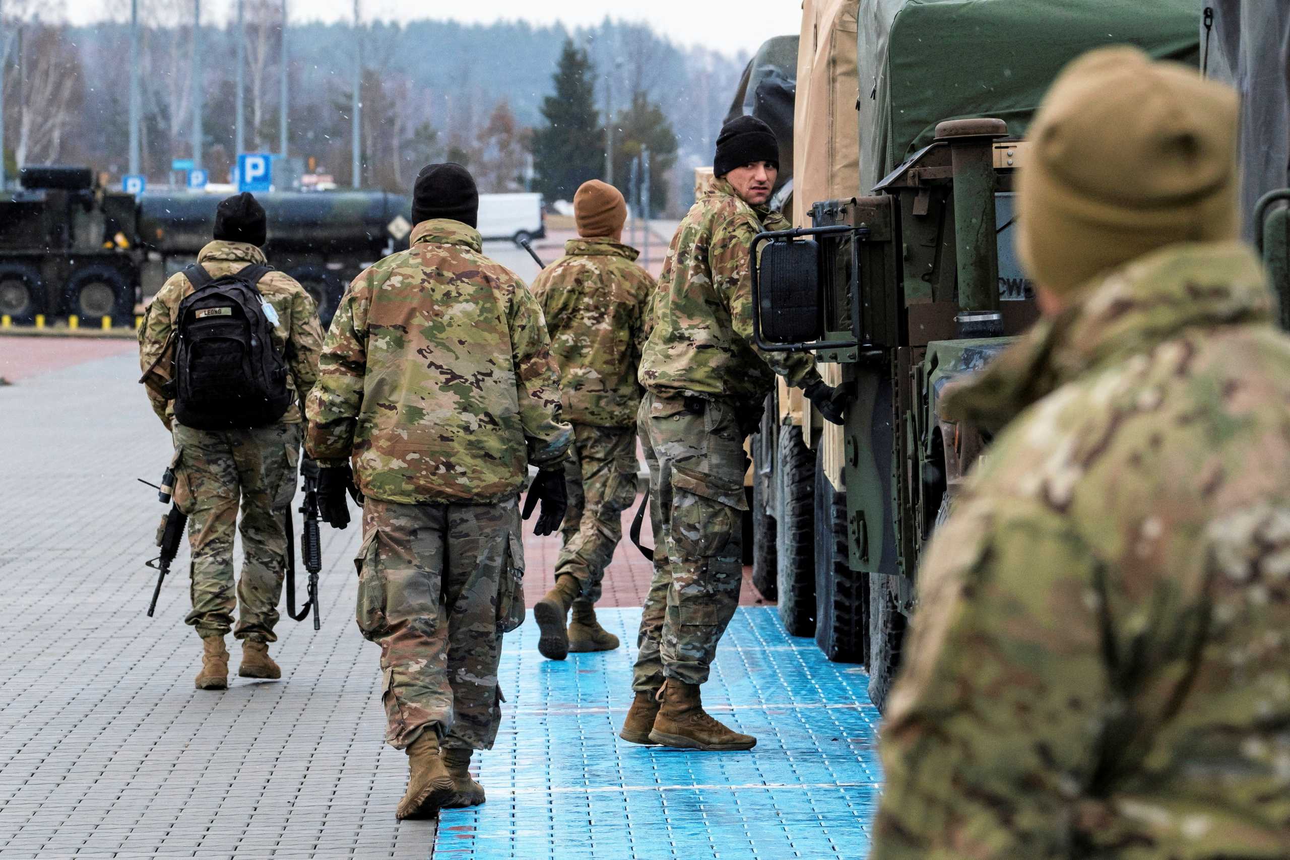 U.S. soldiers are seen next to their vehicles outside the G2A Arena after arriving at Rzeszow-Jasionka Airport in Jasionka, Poland February 6, 2022. Patryk Ogorzalek