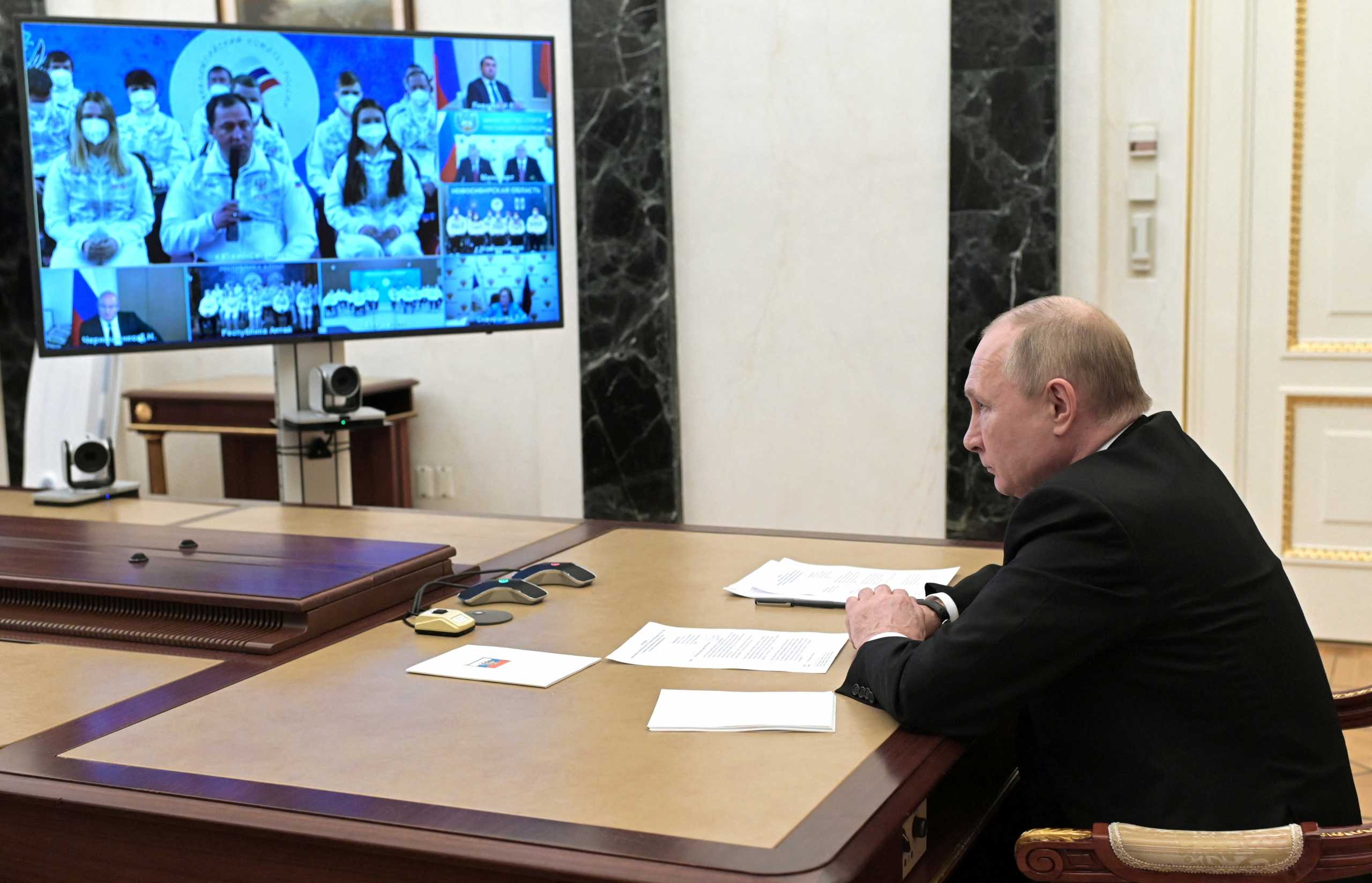 Russian President Vladimir Putin chairs a meeting with members of the country's Paralympic team ahead of the Beijing 2022 Paralympic Winter Games via a video link in Moscow, Russia February 21, 2022. Sputnik