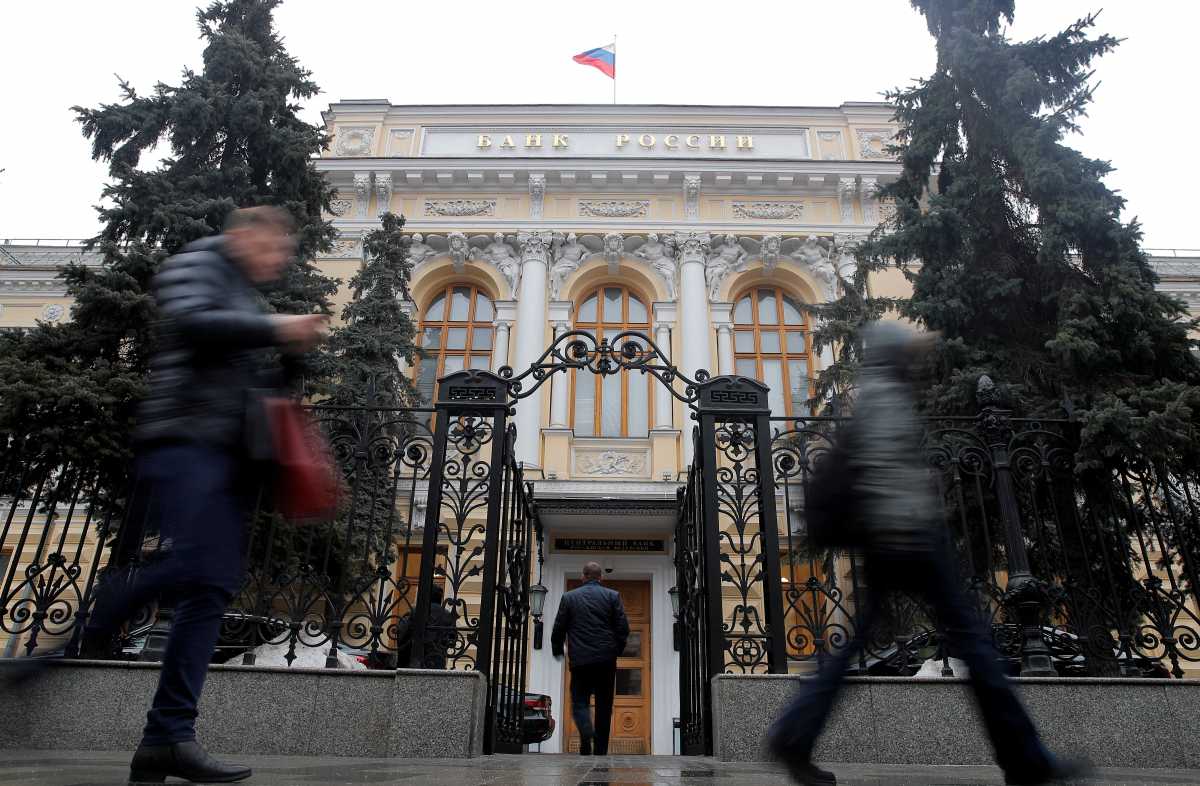 FILE PHOTO: People walk past the Central Bank headquarters in Moscow, Russia February 11, 2019. REUTERS