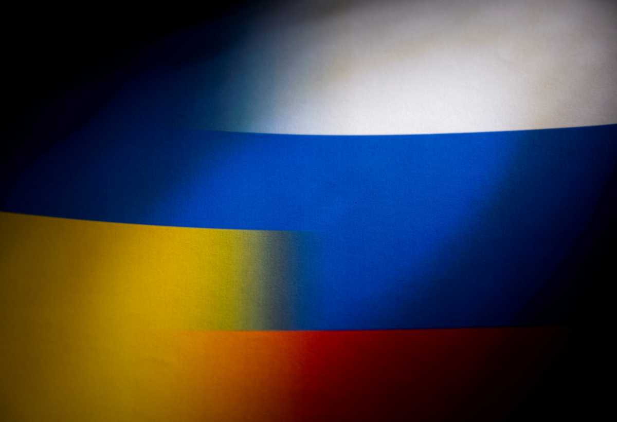 FILE PHOTO: Russia's and Ukraine's flags are seen printed on paper in this illustration taken January 27, 2022. REUTERS