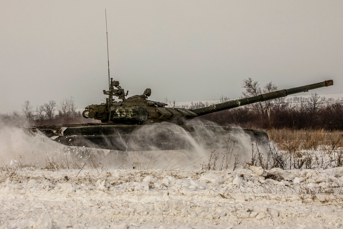 A tank of Russian armed forces drives during military exercises in the Leningrad Region, Russia, in this handout picture released February 14, 2022. Russian Defence Ministry