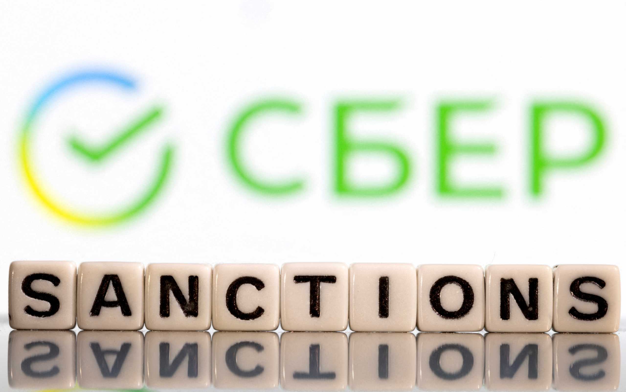 Plastic letters arranged to read "Sanctions" are placed in front of Sberbank bank logo in this illustration taken, Bosnia and Herzegovina, February 25, 2022. REUTERS