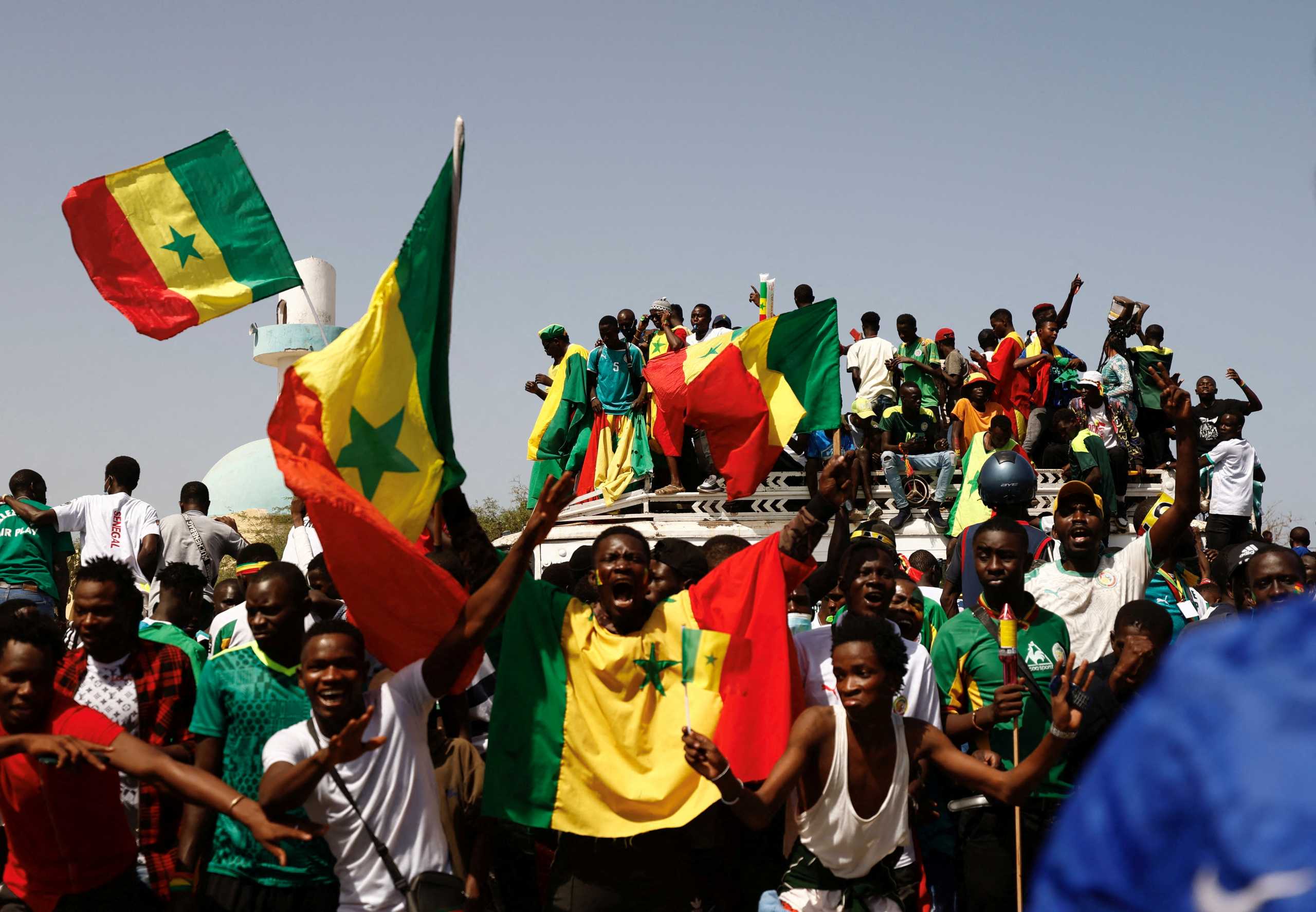 Senegalese fans celebrate as they wait to welcome the Senegal National Soccer Team after their Africa Cup win, in Dakar, Senegal February 7, 2022. REUTERS