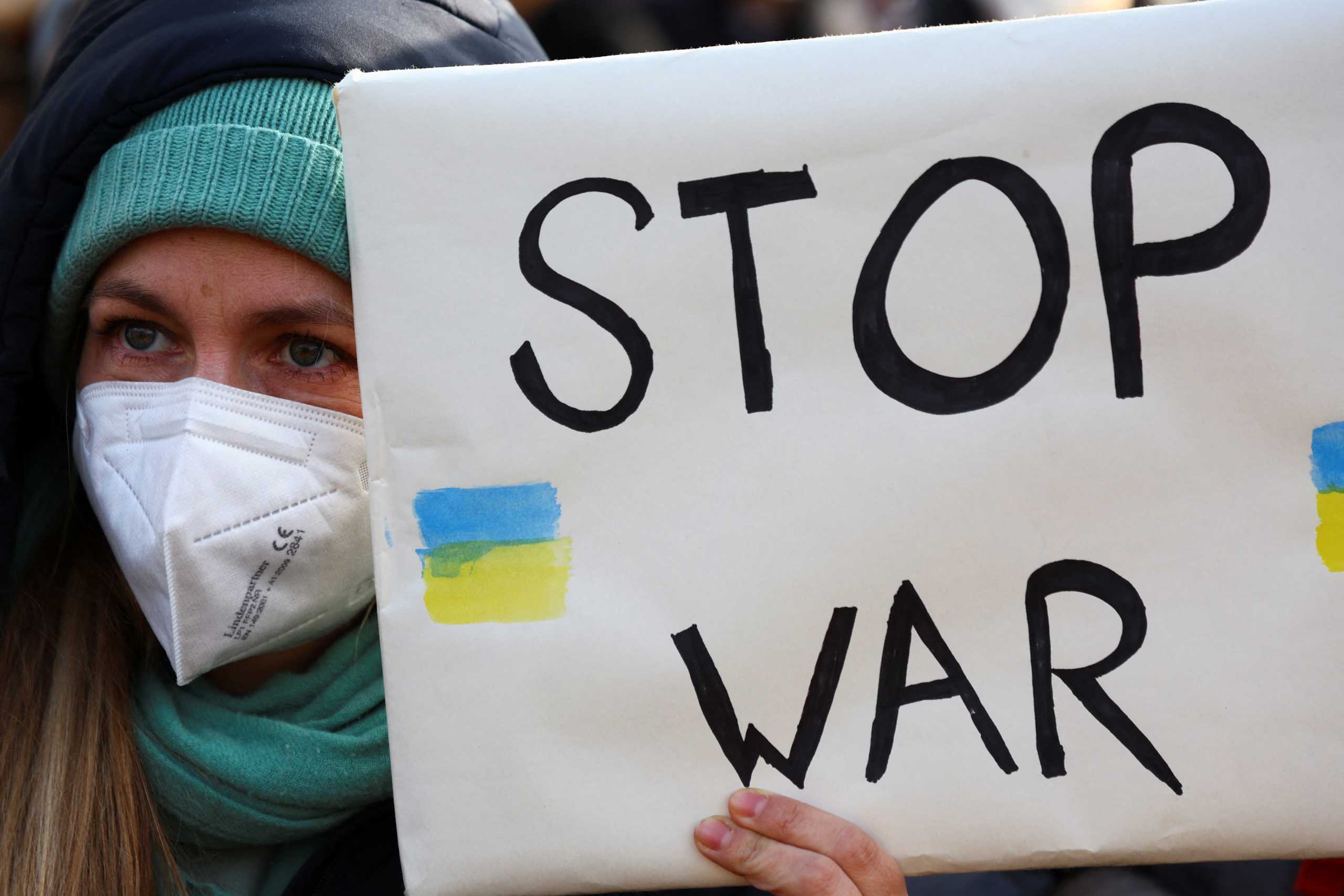 A demonstrator holds a placard during an anti-war protest, after Russia launched a massive military operation against Ukraine, in Berlin, Germany, February 27, 2022. REUTERS
