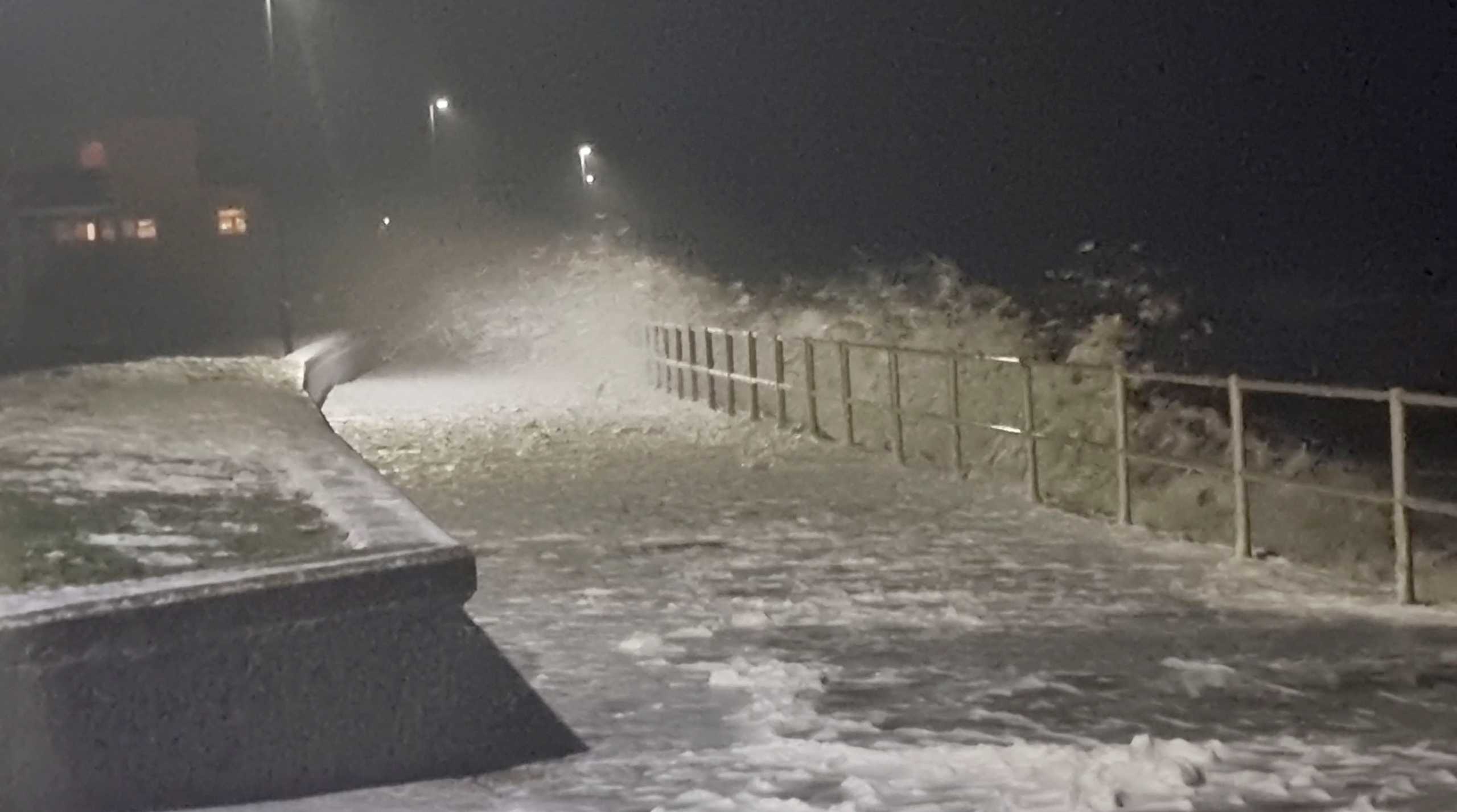 Waves crash into the shore during the Storm Dudley in Tywyn, Wales, Britain February 16, 2022, in this still image obtained from social media video on February 17, 2022.  Stephen Griffiths