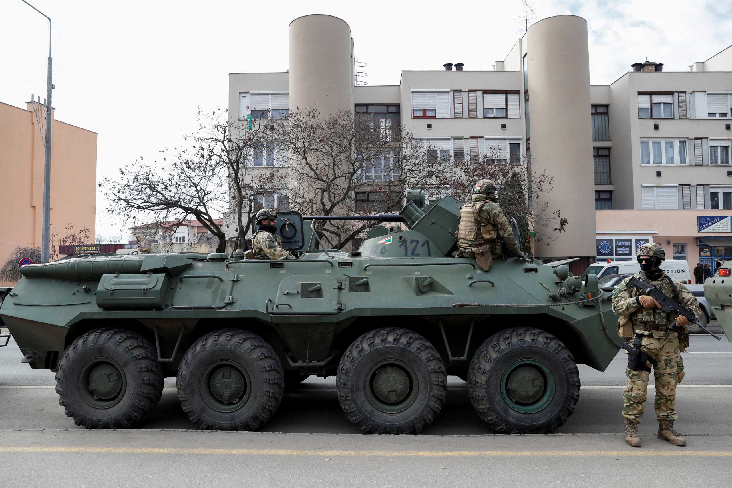 Hungarian army members stand guard as people flee from Ukraine to Hungary, after Russia launched a massive military operation against Ukraine, in Vasarosnameny, Hungary, February 25, 2022. REUTERS