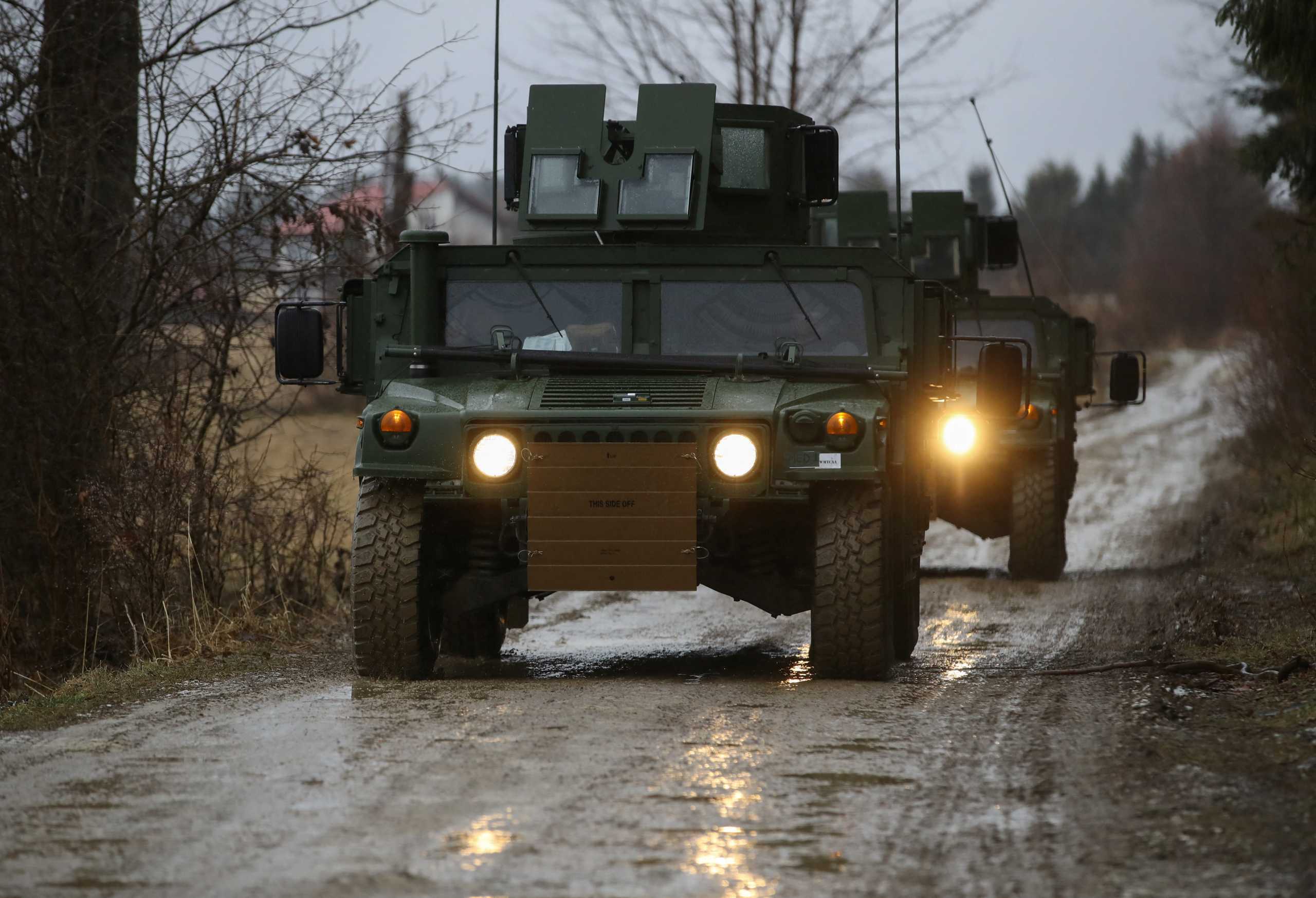 U.S. Army soldiers from the 82nd Airborne Division, deployed to Poland to reassure NATO allies drive HMMWV (Humvee) vehicles towards an airbase, near Arlamow Poland, February 23, 2022. REUTERS