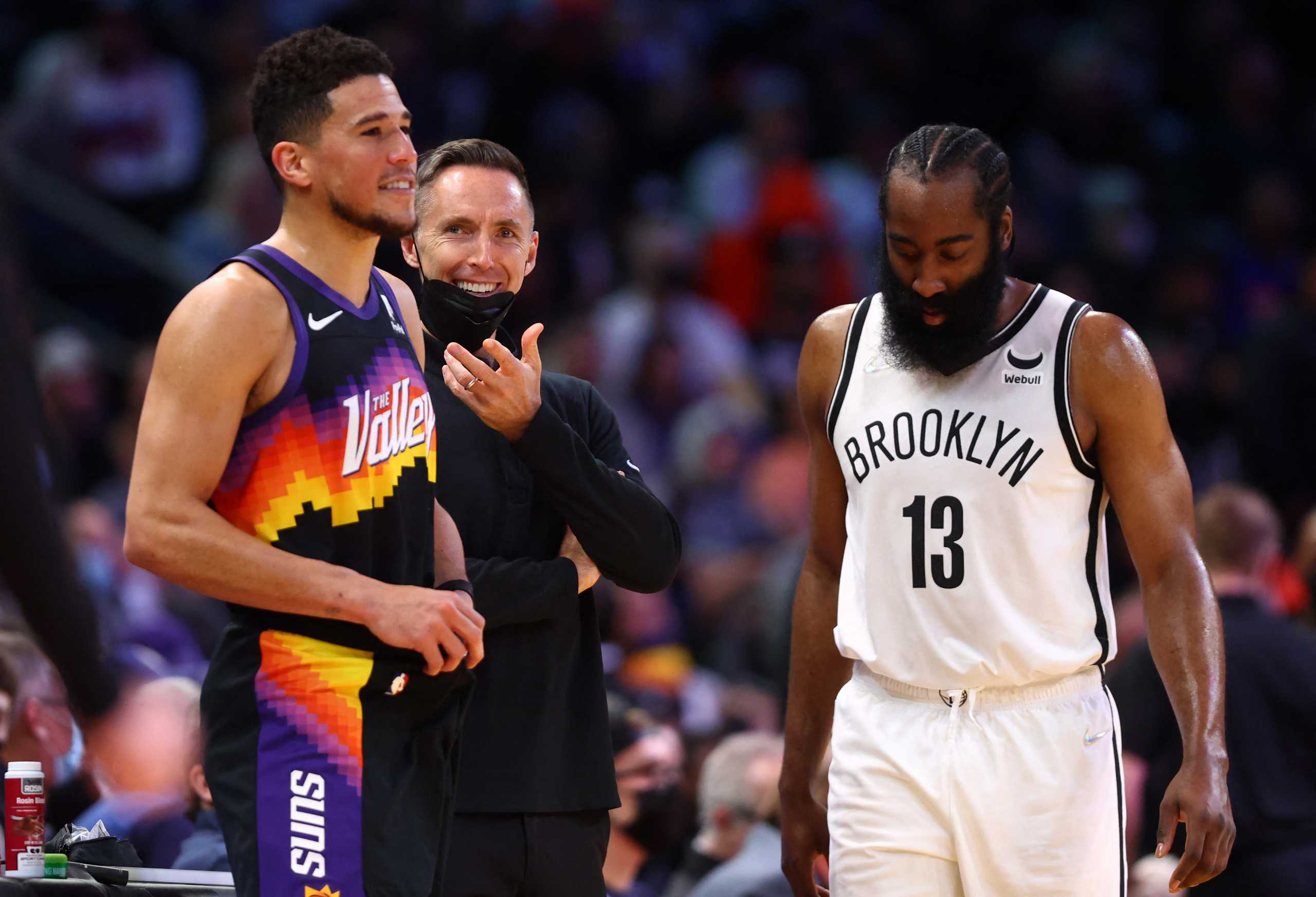 Feb 1, 2022; Phoenix, Arizona, USA; Brooklyn Nets head coach Steve Nash reacts behind guard James Harden (13) and Phoenix Suns guard Devin Booker (1) during the second half at Footprint Center. Mandatory Credit: Mark J. Rebilas-USA TODAY Sports