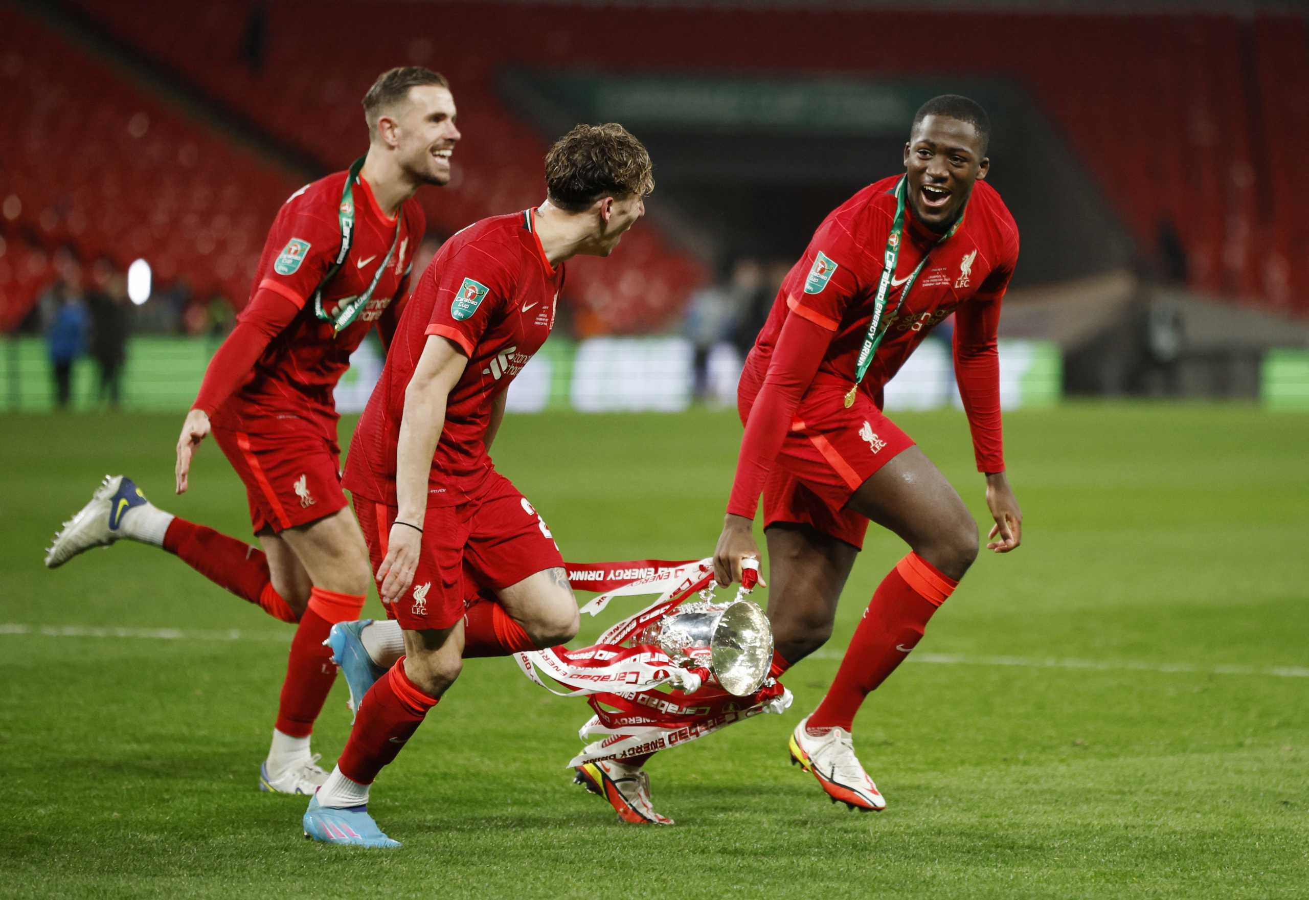Soccer Football - Carabao Cup Final - Chelsea v Liverpool - Wembley Stadium, London, Britain - February  27, 2022  Liverpool's Jordan Henderson, Kostas Tsimikas and Ibrahima Konate celebrate with the trophy after winning the Carabao Cup Action Images via Reuters