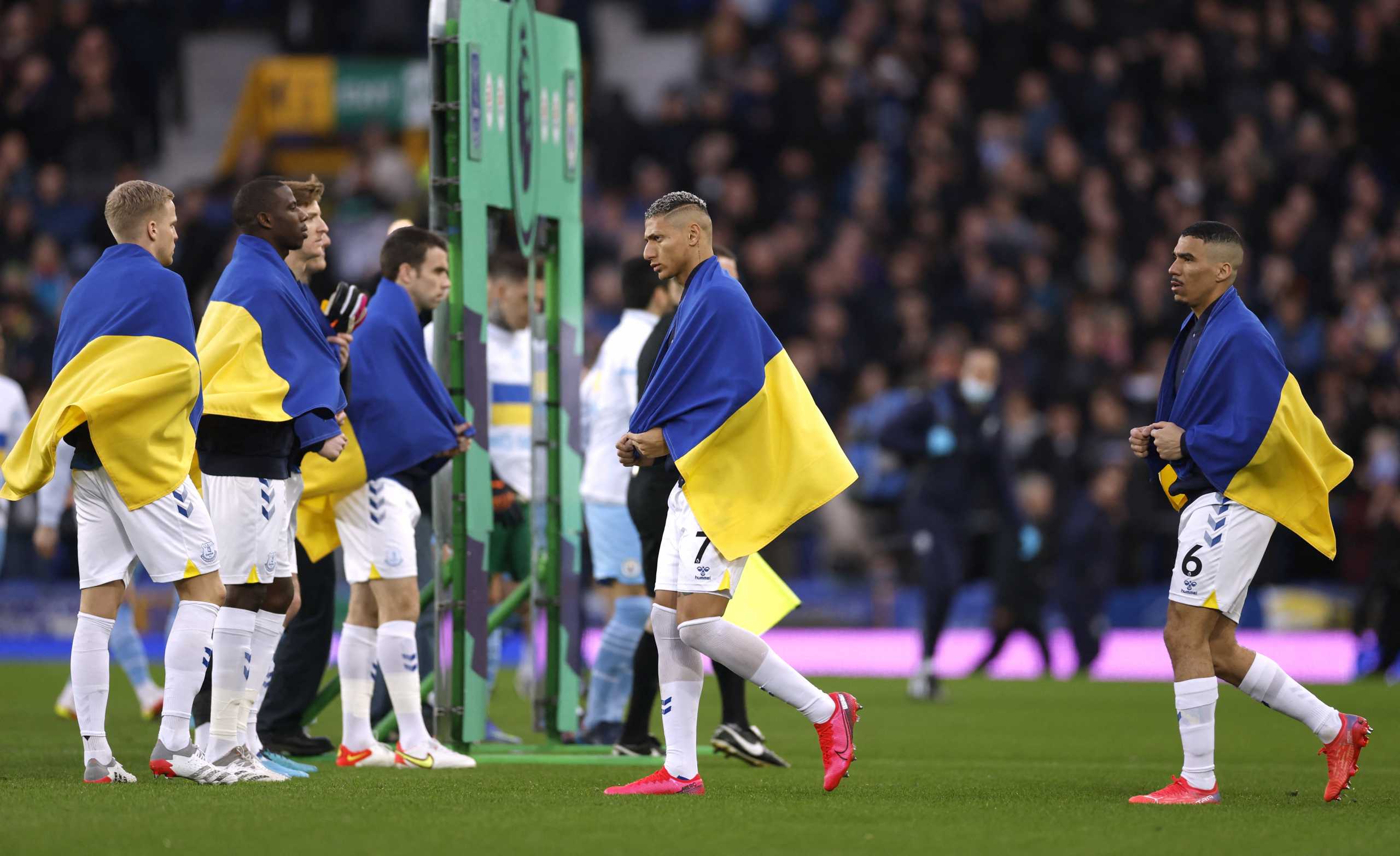 Soccer Football - Premier League - Everton v Manchester City - Goodison Park, Liverpool, Britain - February 26, 2022 Everton's Richarlison draped in a Ukraine flag before the match Action Images via Reuters