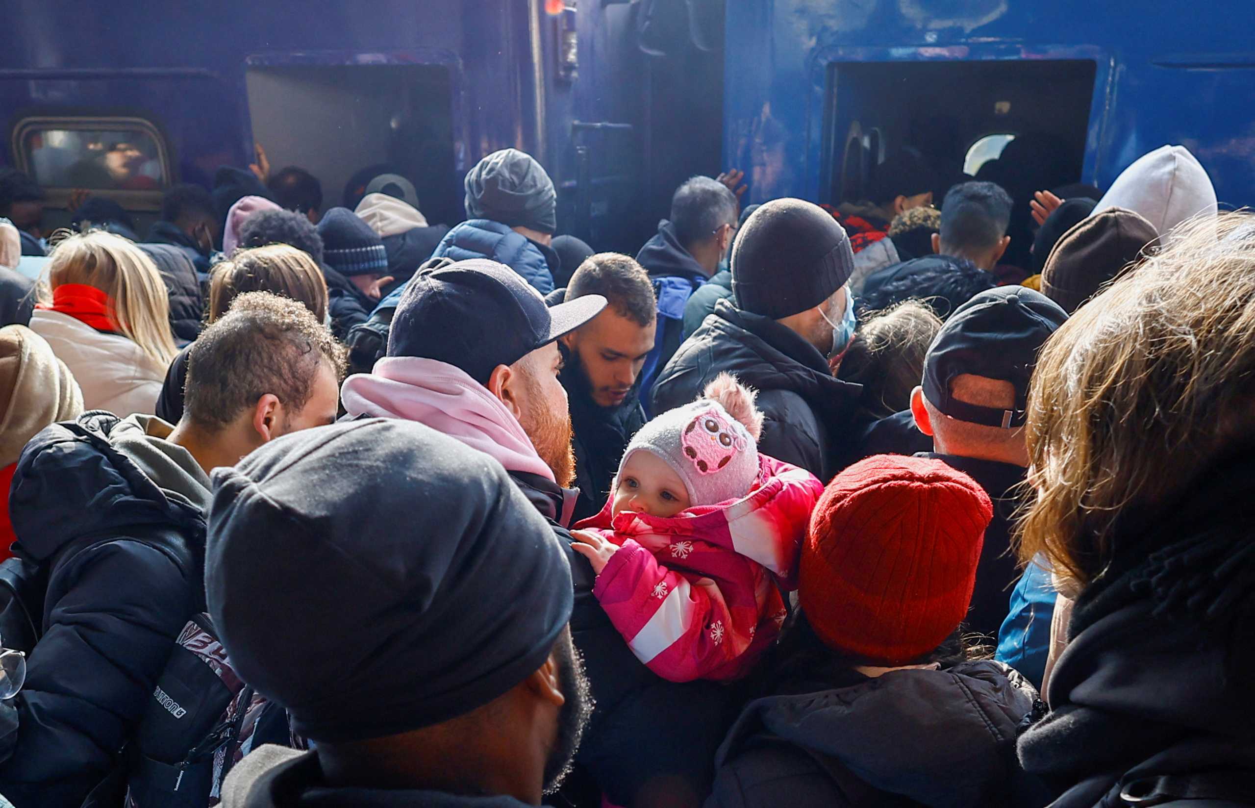 People wait to board an evacuation train from Kyiv to Lviv at Kyiv central train station, Ukraine, February 25, 2022. REUTERS